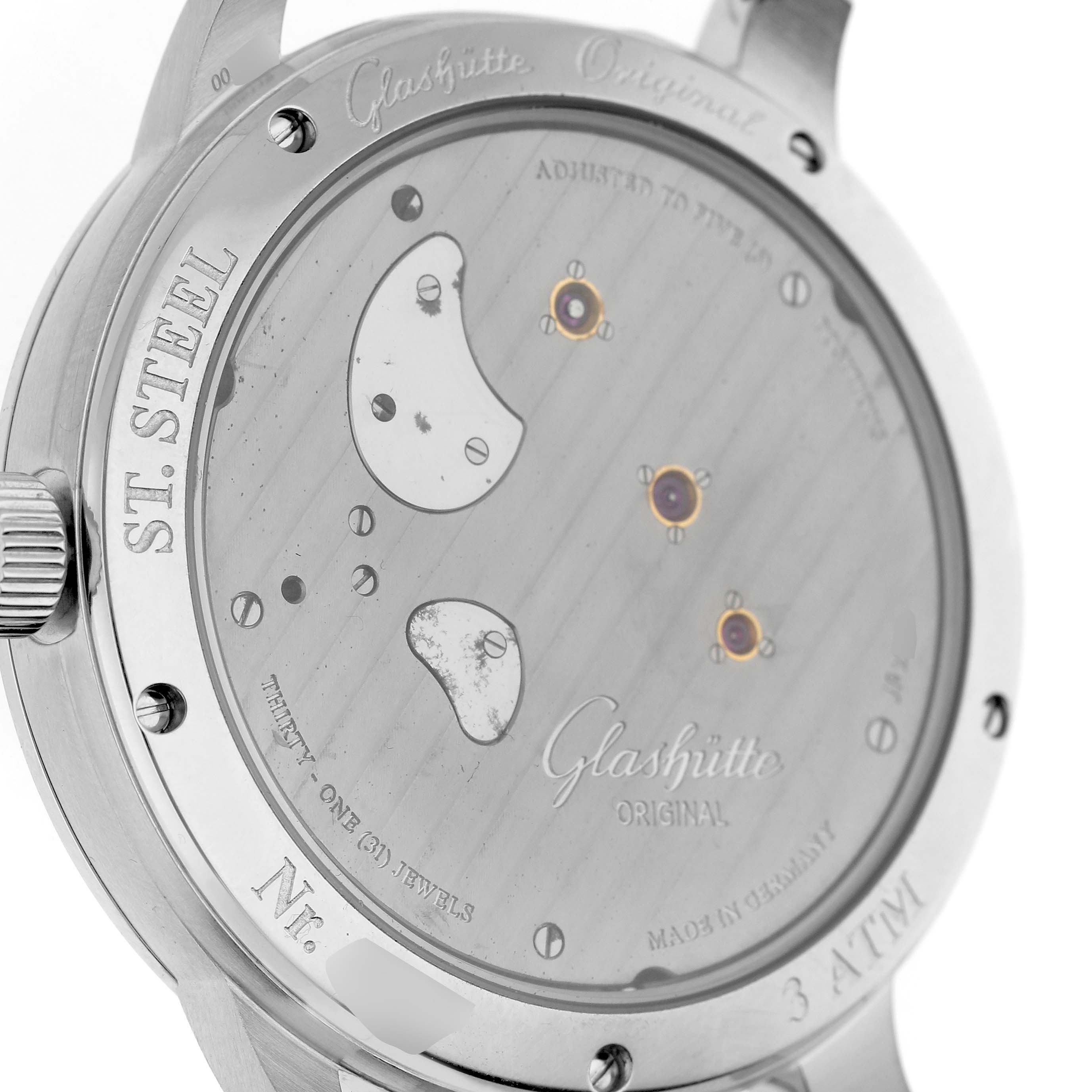 The image shows the back of the Glashütte Pano watch, displaying its stainless steel case and intricate movement.