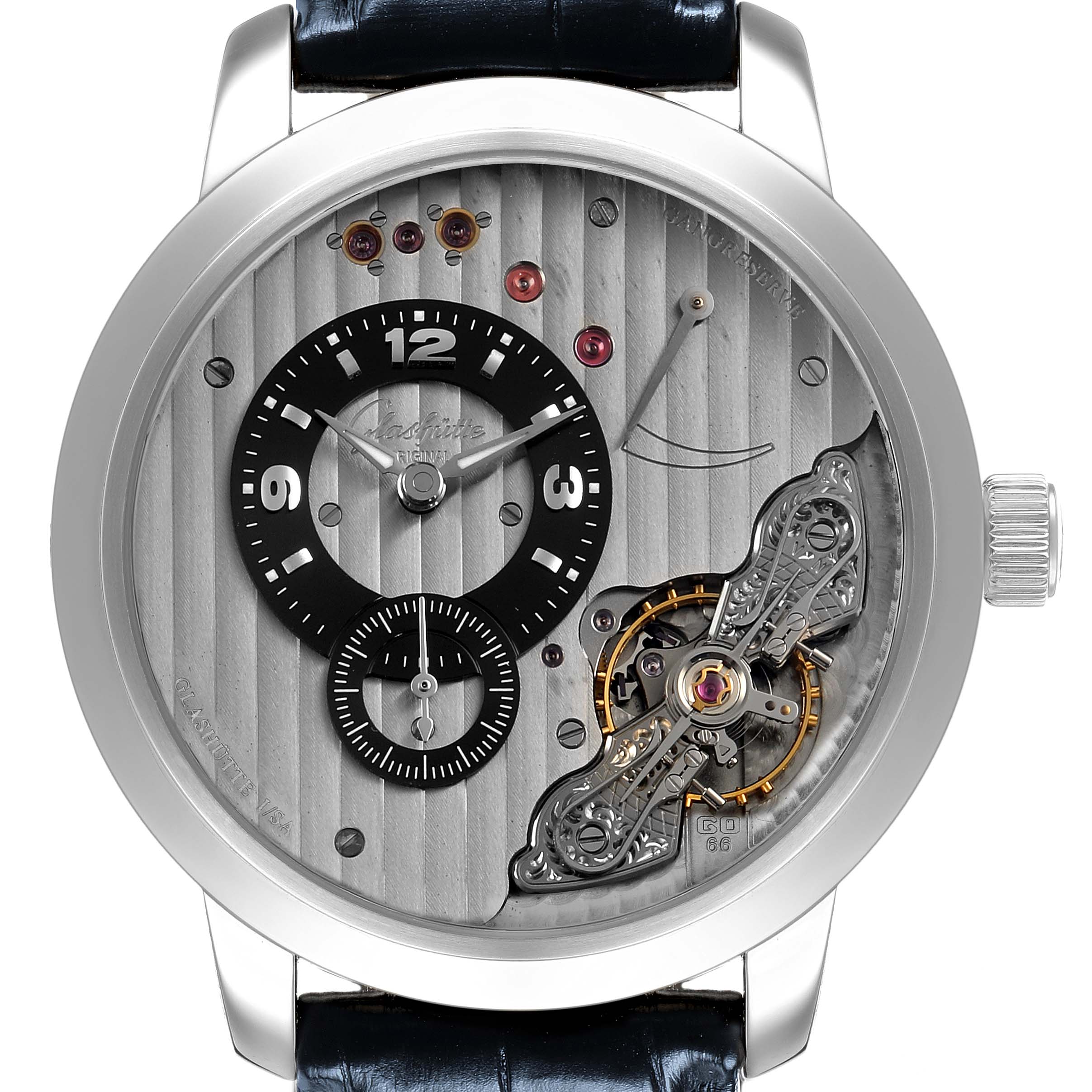 The Glashütte Pano watch is shown face-on, highlighting the off-center dial, exposed mechanics, and sleek metal case.