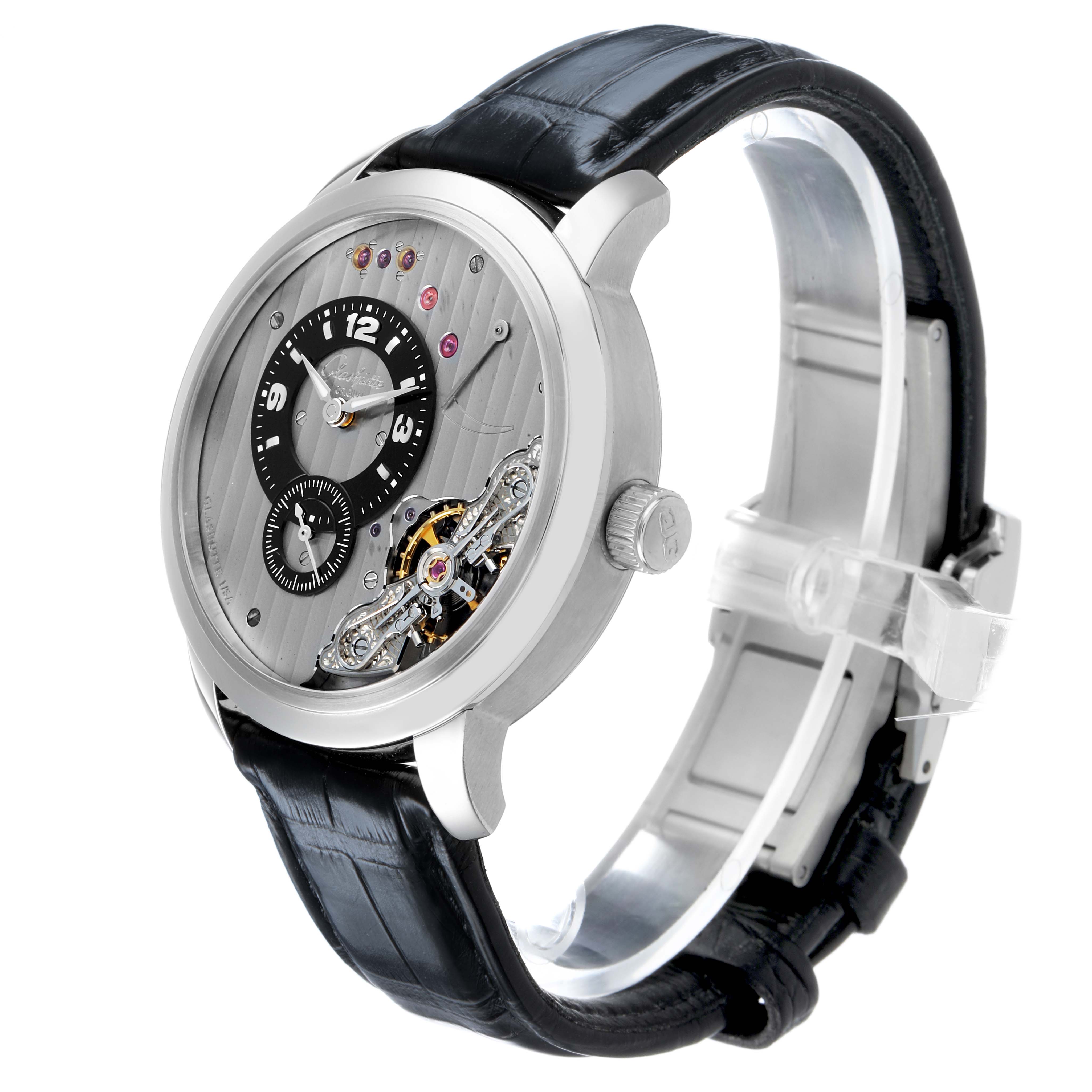 The Glashütte Pano watch is shown at a slight angle, highlighting the dial, crown, leather strap, and movement details.