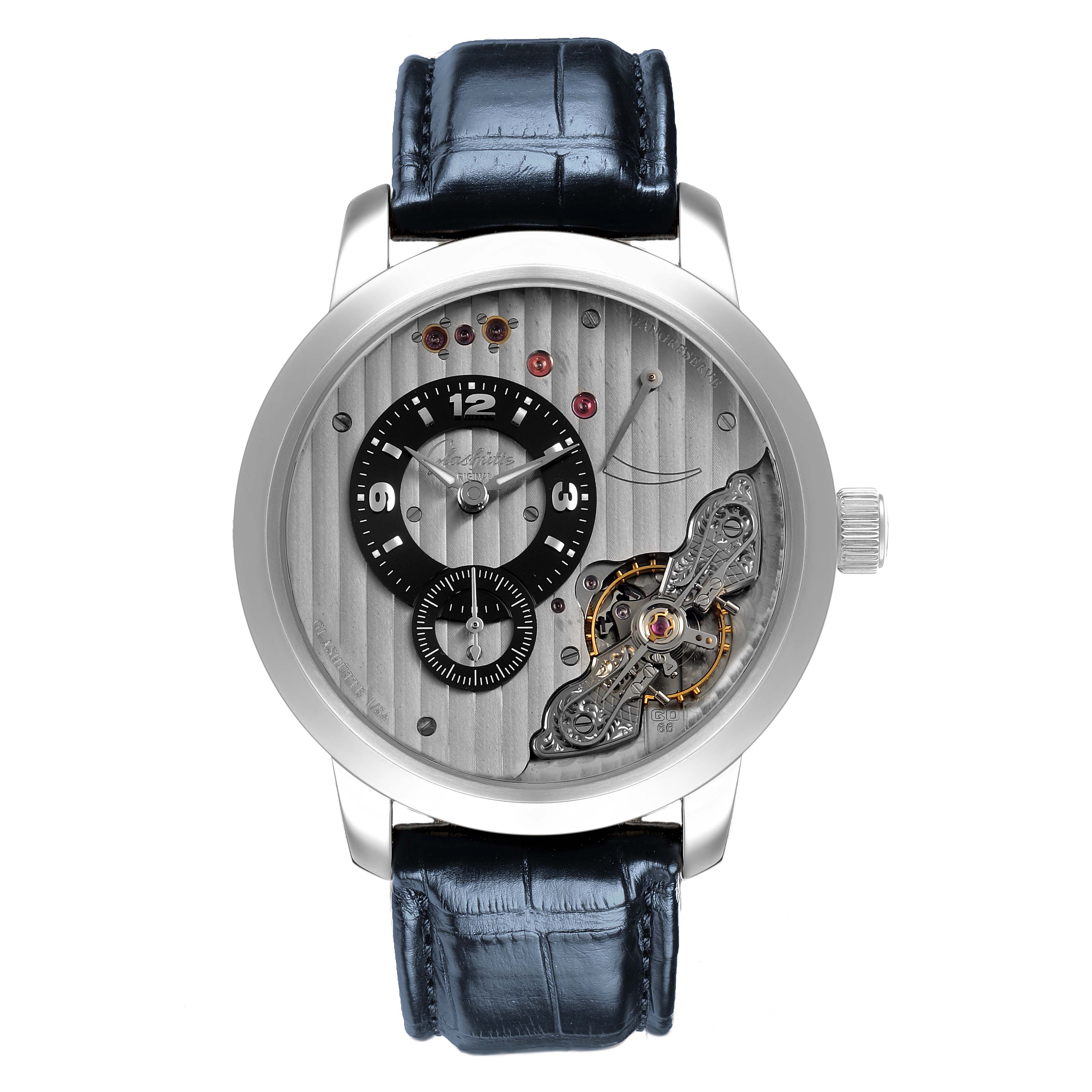The Glashütte Pano watch is shown from the front, highlighting its dial, subdials, and visible movement parts.