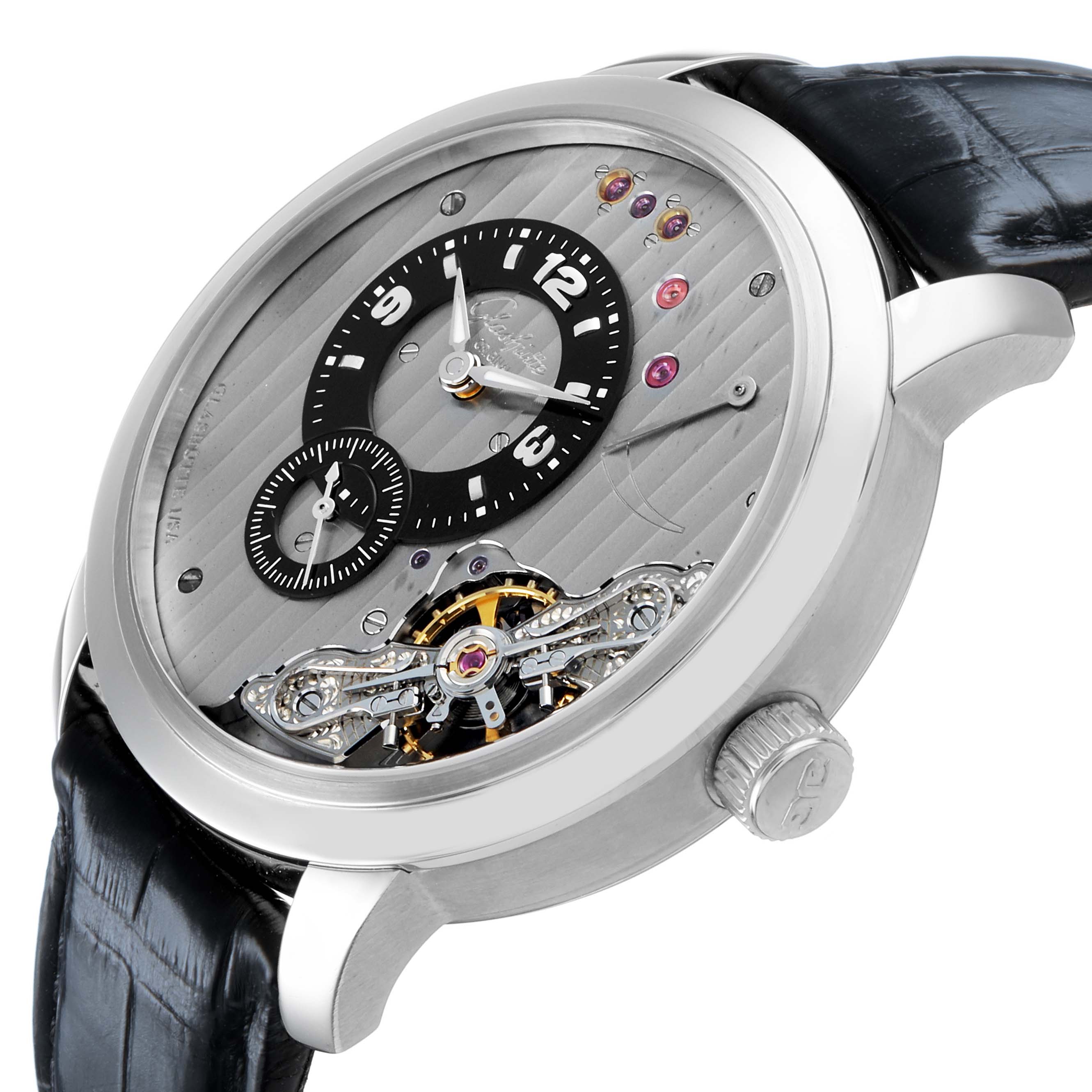 The Glashütte Pano watch is shown at a three-quarter angle, highlighting its dial, sub-dial, and visible movement with a black strap.