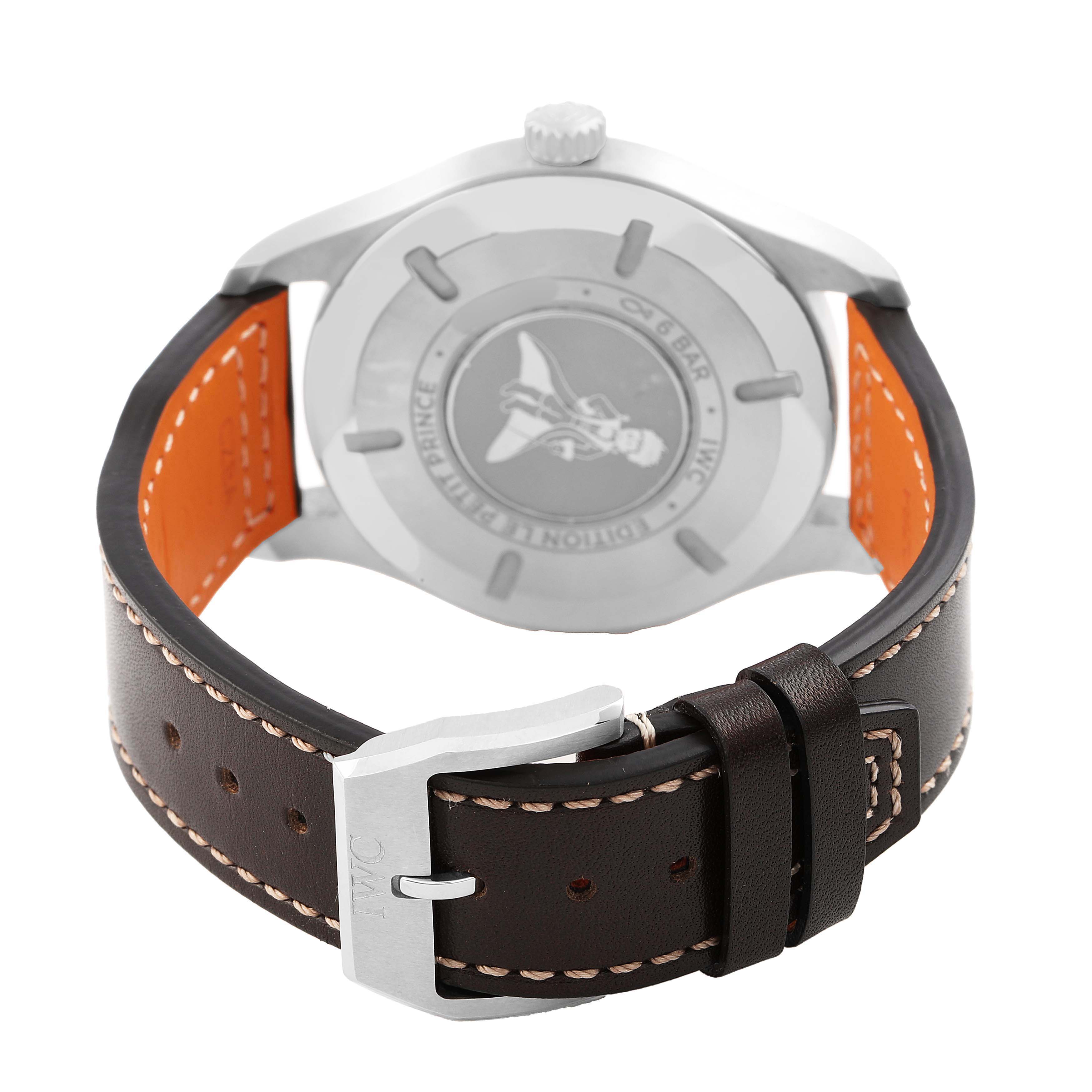 The IWC Pilot IW327010 Men's Stainless Steel Blue Dial watch is shown from a rear angle, highlighting its case back, leather strap, and buckle.