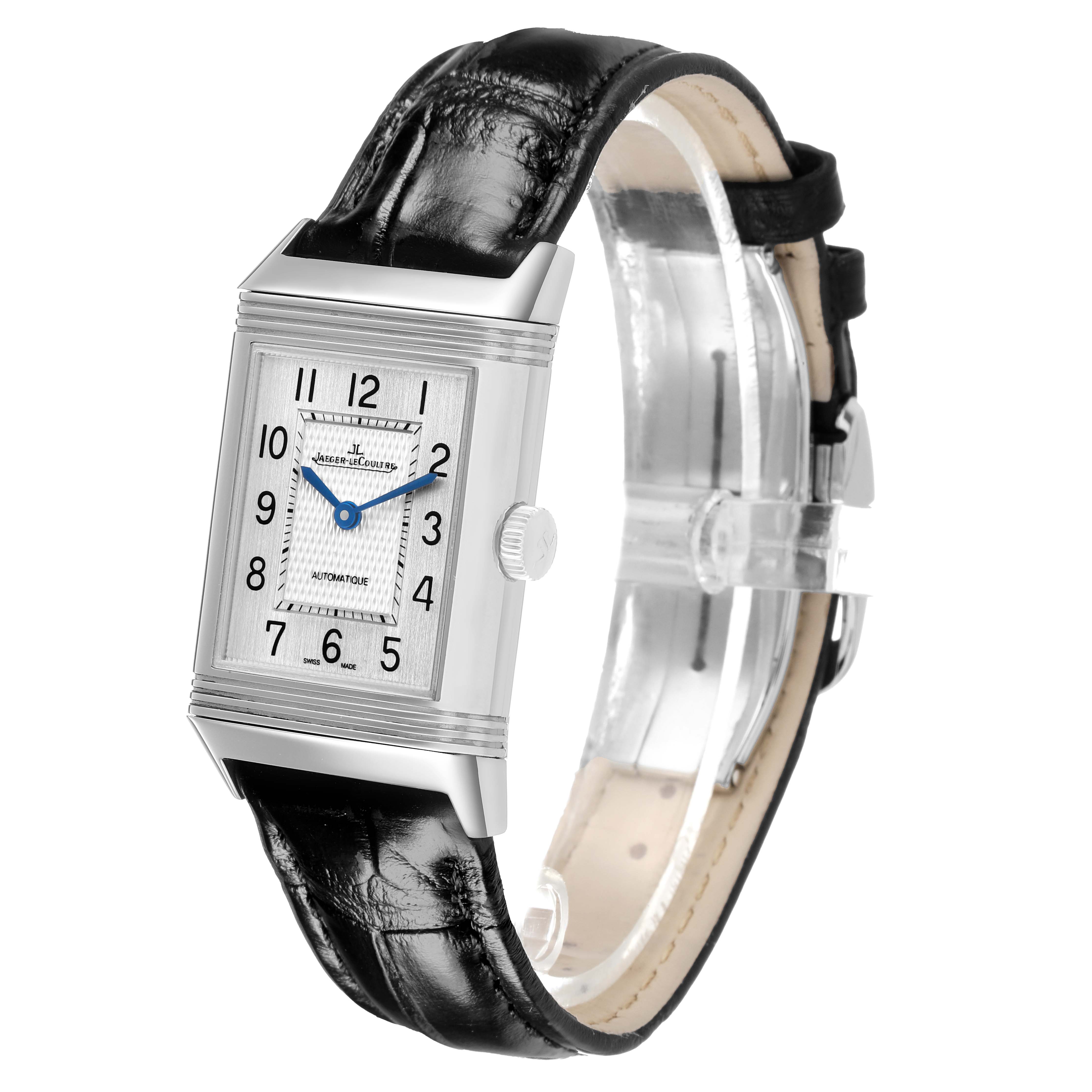 The Jaeger-LeCoultre Reverso watch is shown at a slight angle highlighting the rectangular face, blue hands, and black leather strap.