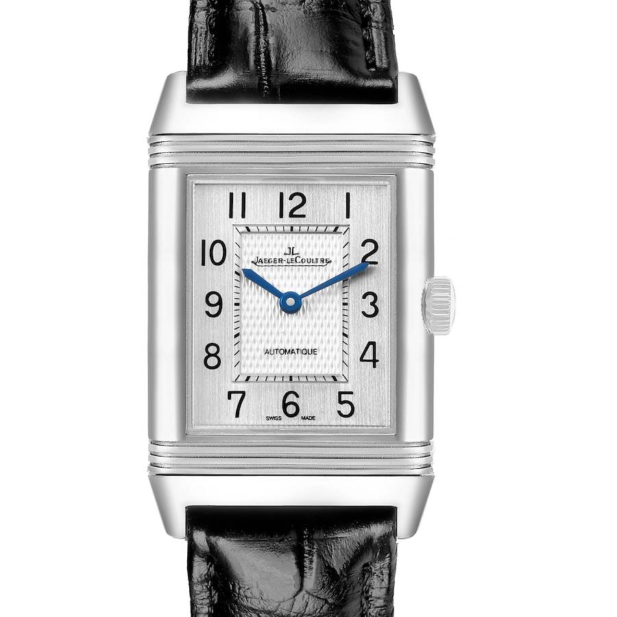 The Jaeger-LeCoultre Reverso watch is shown from a frontal angle, displaying its rectangular face, dial, and crown.