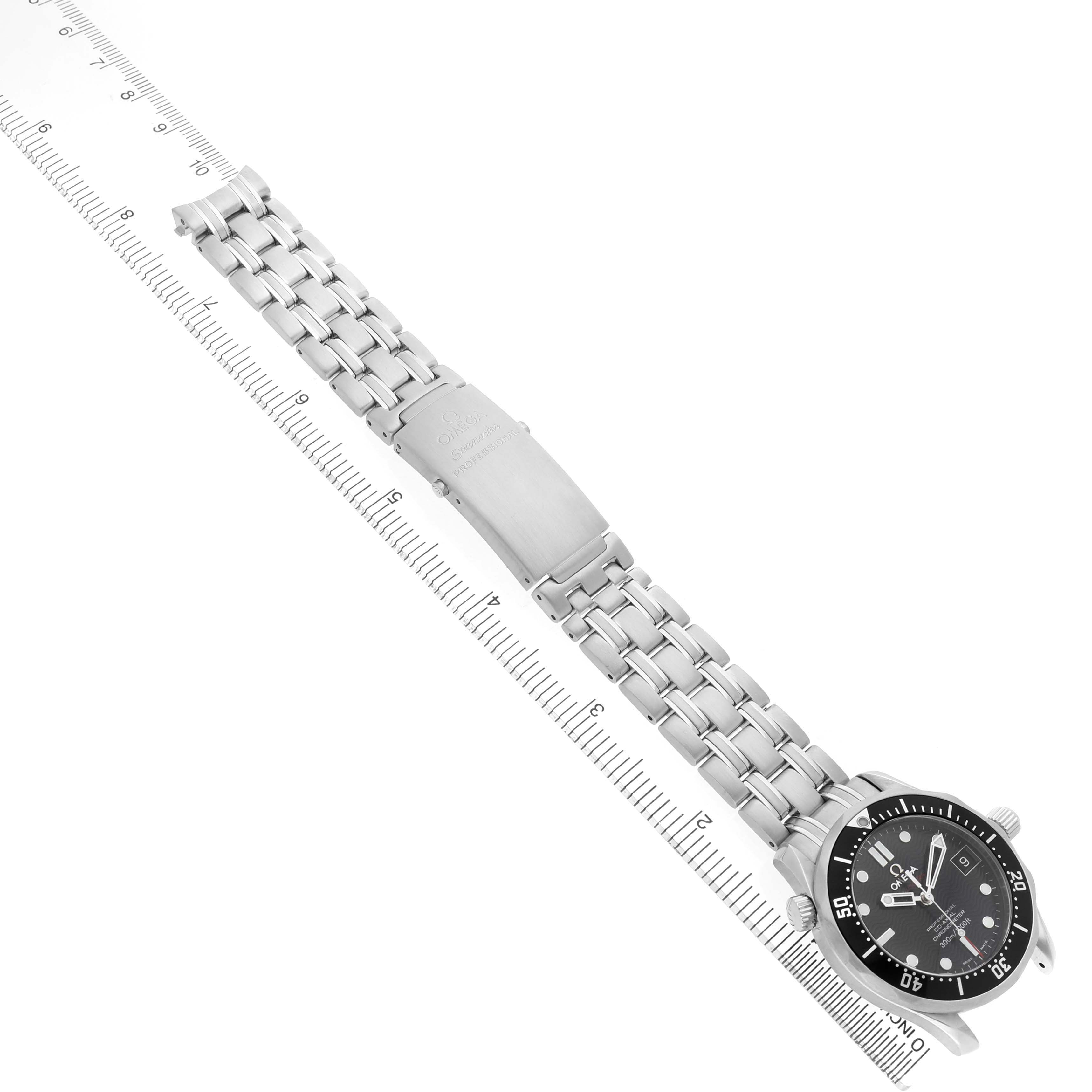 The Omega Seamaster 212.30.36.20.01.001 Men's Stainless Steel Black Dial watch is shown at an angle highlighting the face and stainless steel bracelet, aligned with a ruler for scale.