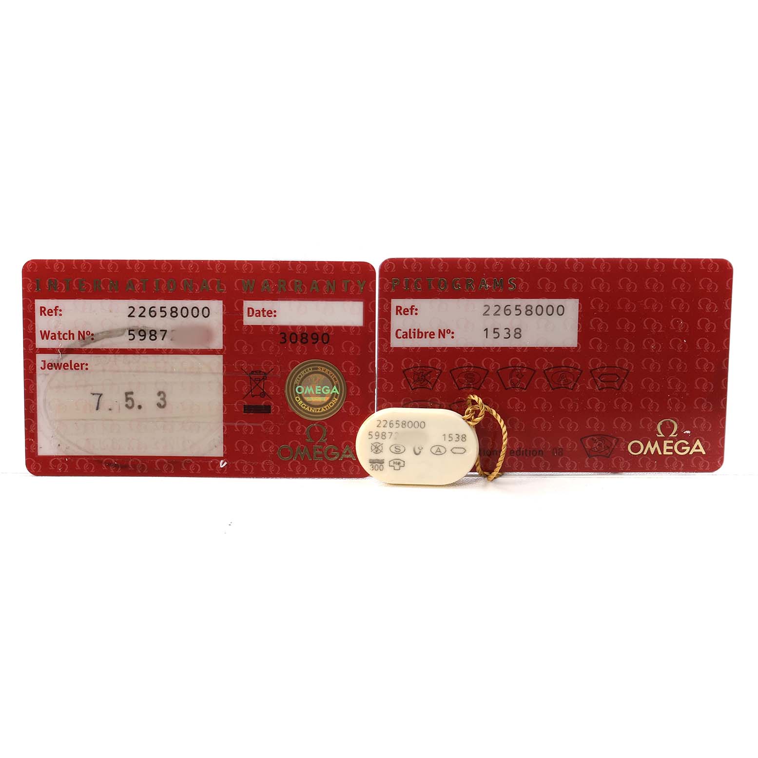 The image shows warranty cards and a tag for an Omega Seamaster 2265.80.00 Men's Stainless Steel Blue Dial watch, displaying reference numbers and details.
