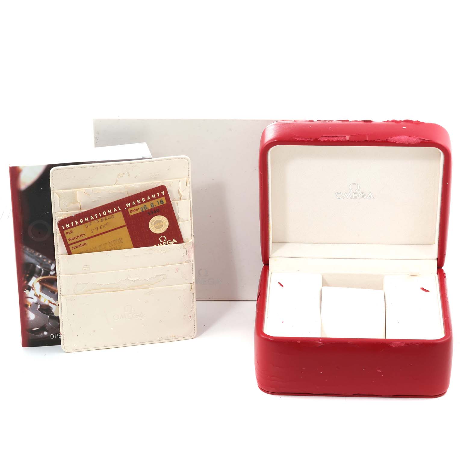 This image shows the packaging and accessories for an Omega Speedmaster 3513.54.00 Men's Stainless Steel Black Dial 3513.54.00 Men's Stainless Steel Black Dial, including the red watch box, warranty card, cardholder, and documentation.