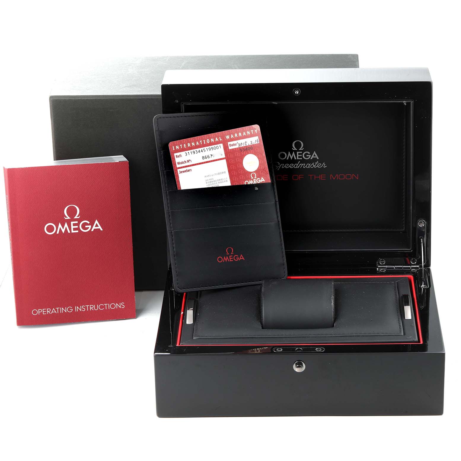 The image shows the packaging, warranty card, and operating instructions for the Omega Speedmaster 311.93.44.51.99.001 Men's Ceramic Silver Dial 311.93.44.51.99.001 Men's Ceramic Silver Dial watch from a front angle.