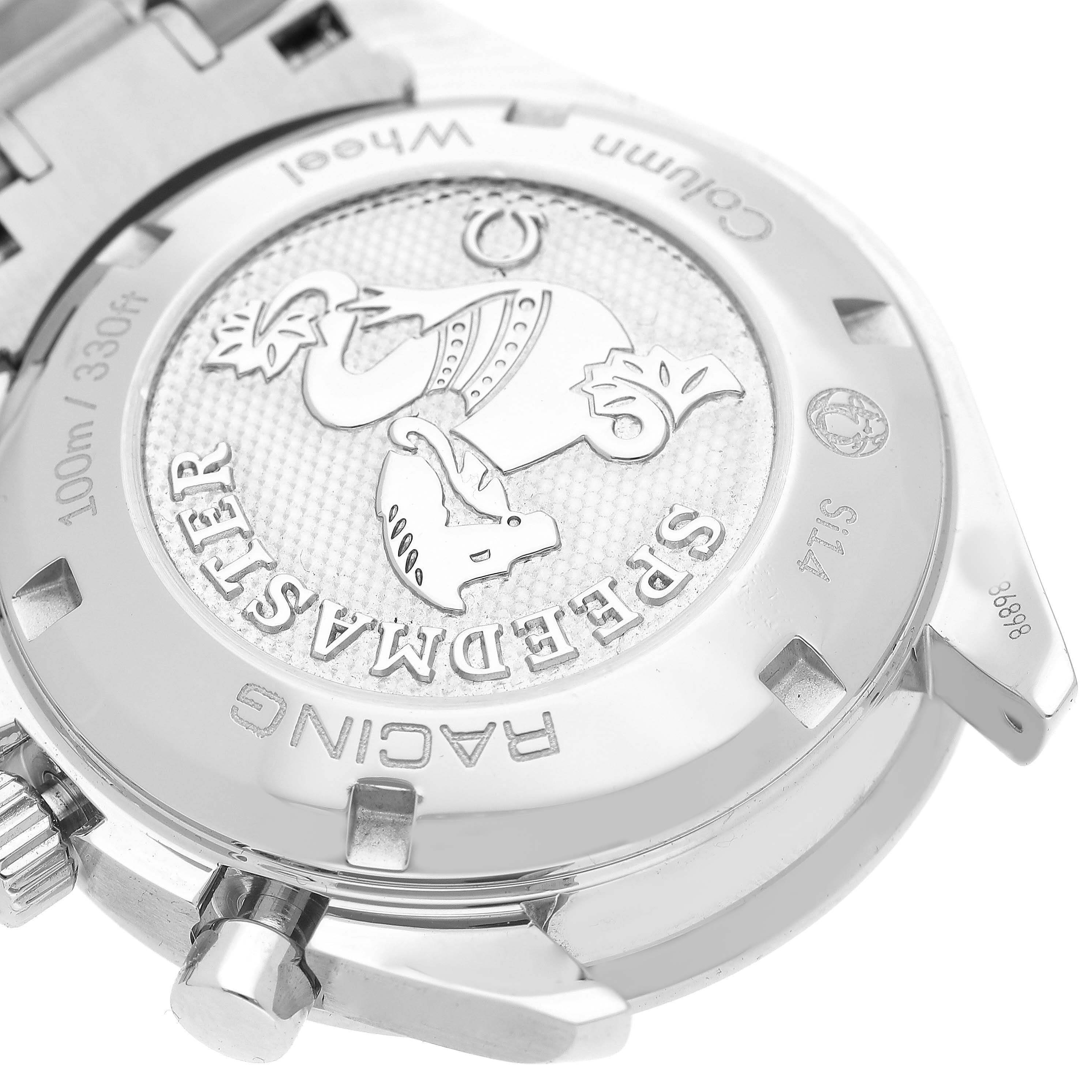 The image shows the case back of an Omega Speedmaster 326.30.40.50.03.001 Men's Stainless Steel Blue Dial Racing watch, featuring embossed details and text.