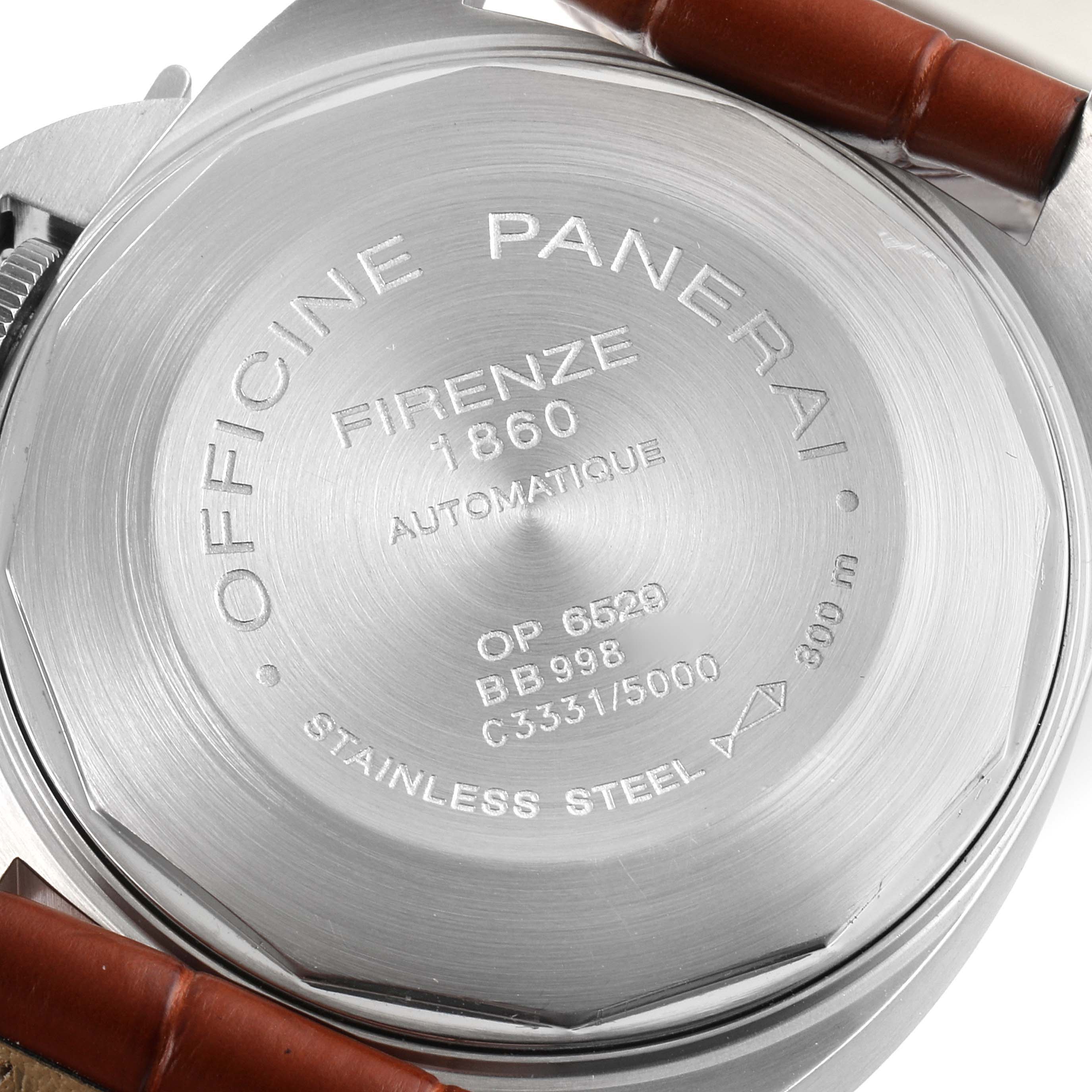 The image shows the back case of a Luminor model by Panerai, featuring engravings and a brown leather strap.