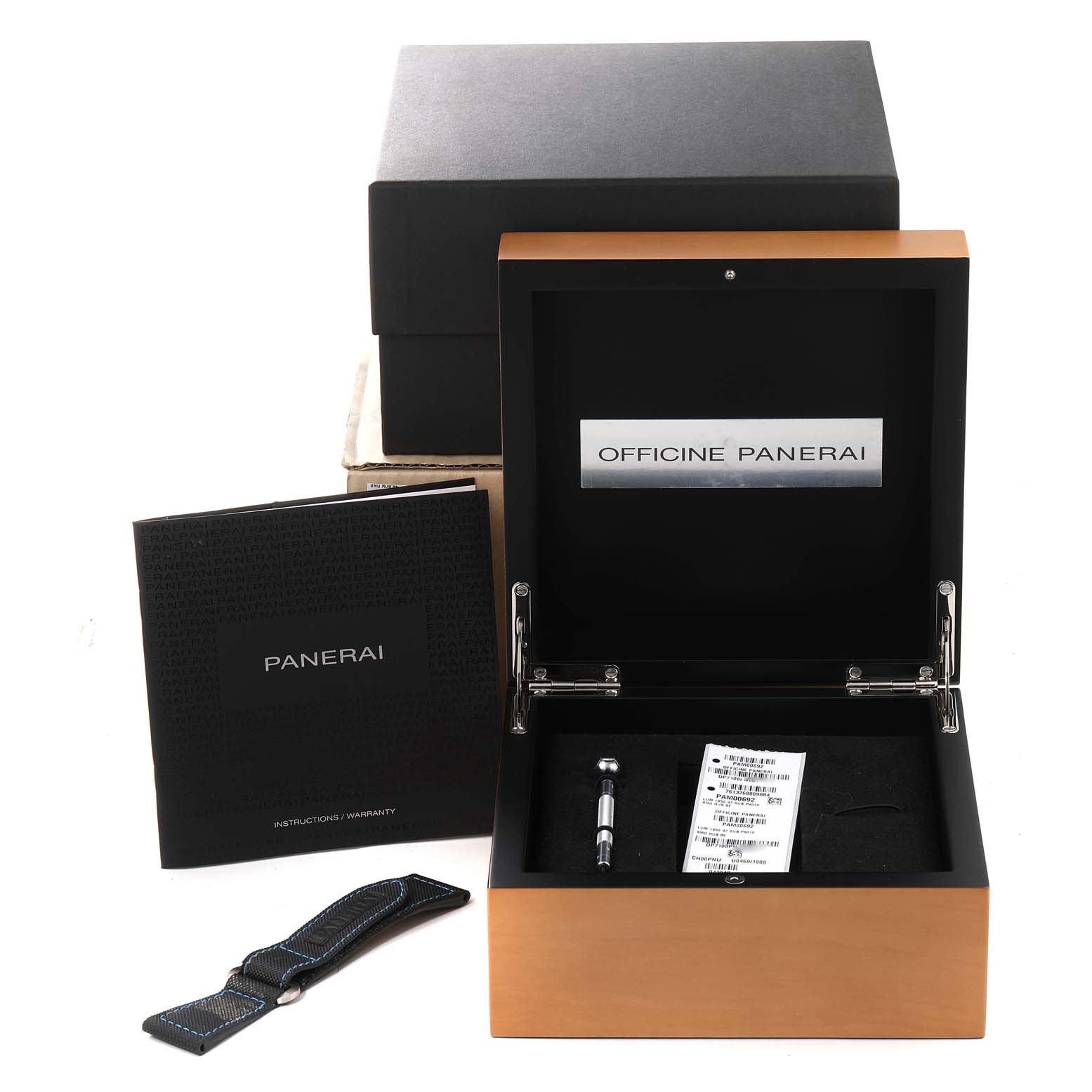 This image shows the Panerai Submersible PAM00692 Men's Ceramic Blue Dial PAM00692 Men's Ceramic Blue Dial watch packaging box, instruction manual, spare strap, and tools from a front angle.