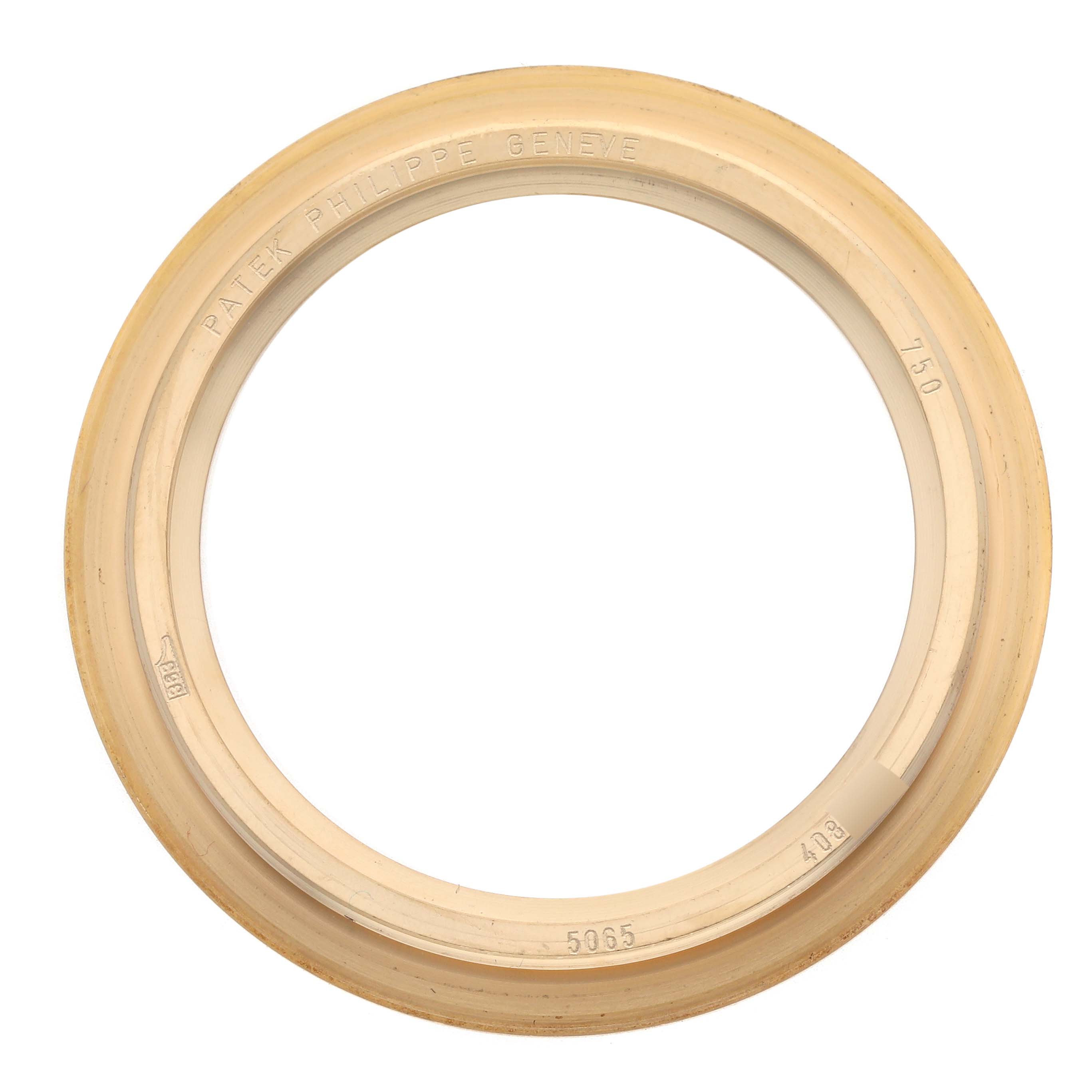 This image shows a gold bezel from a Patek Philippe Aquanaut 5065J Men's Yellow Gold Black Dial 5065J Men's Yellow Gold Black Dial watch viewed from above.