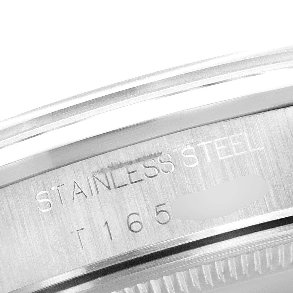 This image shows a close-up of the stainless steel casing with engravings on a Rolex Air-King 14000 Men's Stainless Steel Pink Dial 14000 Men's Stainless Steel Pink Dial watch.