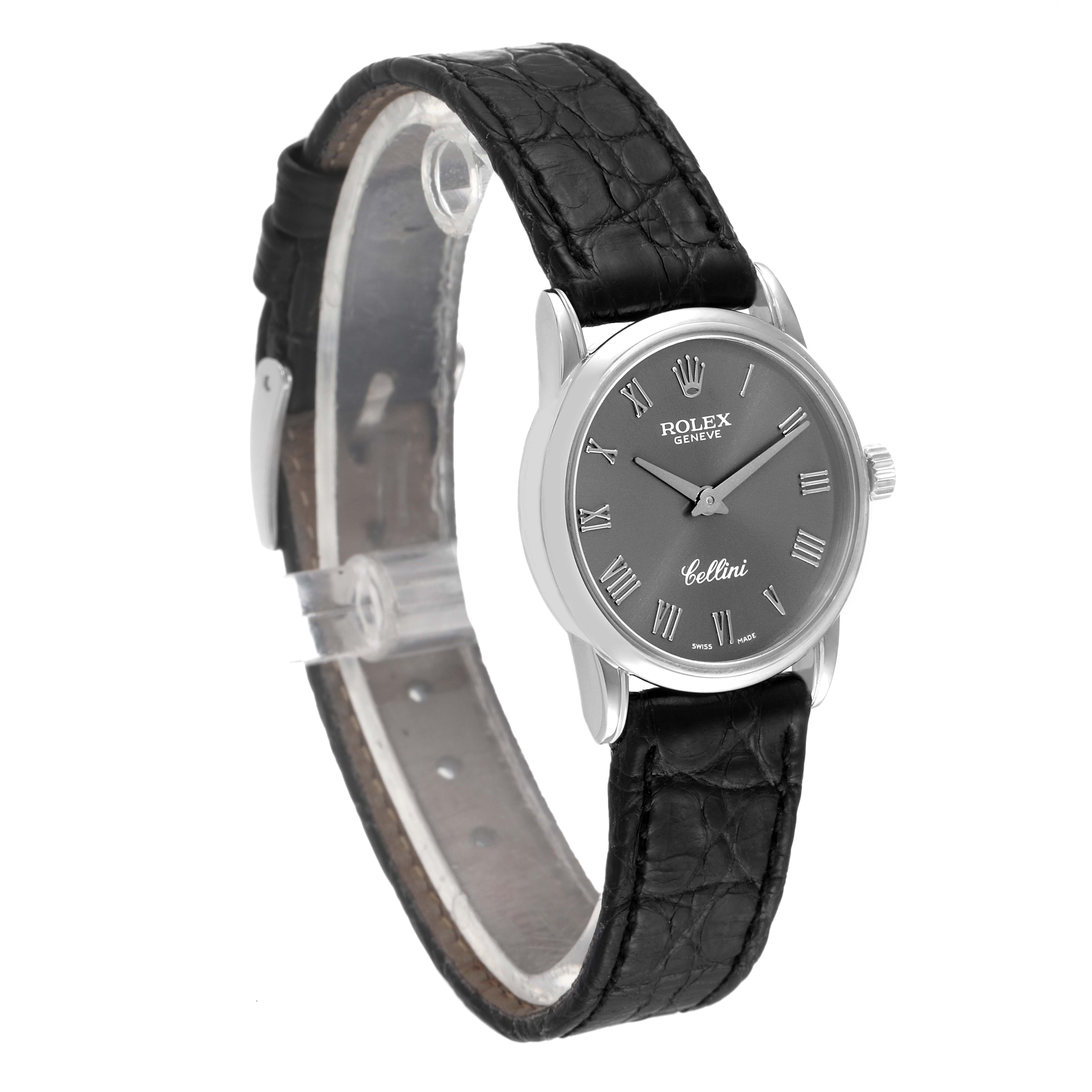 The image shows a Rolex Cellini 6111 Women's White Gold Grey Dial 6111 Women's White Gold Grey Dial watch from a side angle, highlighting its black leather strap and silver dial with Roman numerals.