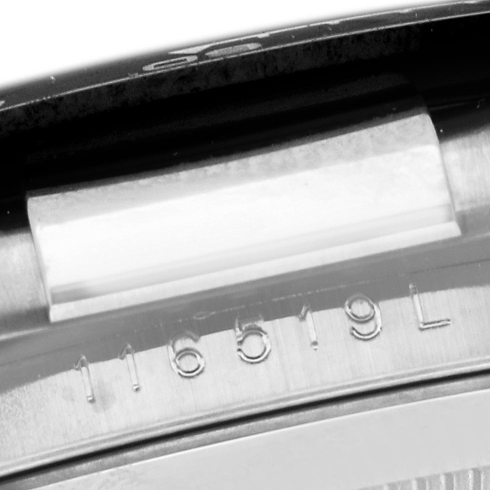 The image shows a close-up of the Rolex Daytona 116519 Men's White Gold Silver Dial 116519 Men's White Gold Silver Dial model's case with visible serial numbers.
