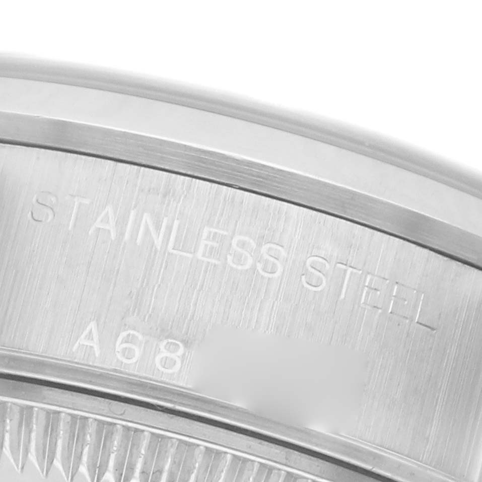 The image shows the side engraving of a Rolex Date 79160 Women's Stainless Steel Black Dial 79160 Women's Stainless Steel Black Dial watch, highlighting "STAINLESS STEEL" on the casing.
