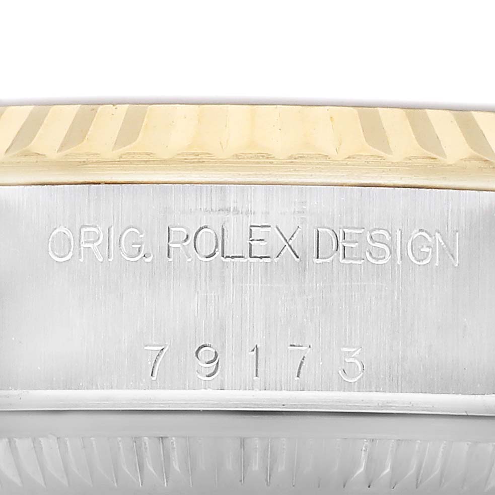 This image shows the side of a Rolex Datejust 79173 Women's Steel and Gold (two tone) Champagne Dial watch, highlighting the engraved model number 79173 and "ORIG. ROLEX DESIGN".