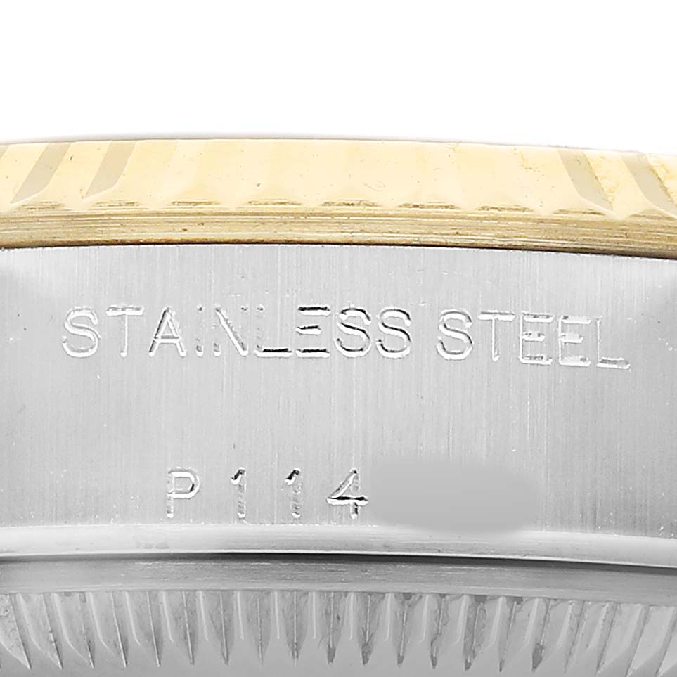 The image shows a close-up of the case side of a Rolex Datejust 79173 Women's Steel and Gold (two tone) Champagne Dial, highlighting the stainless steel engraving.