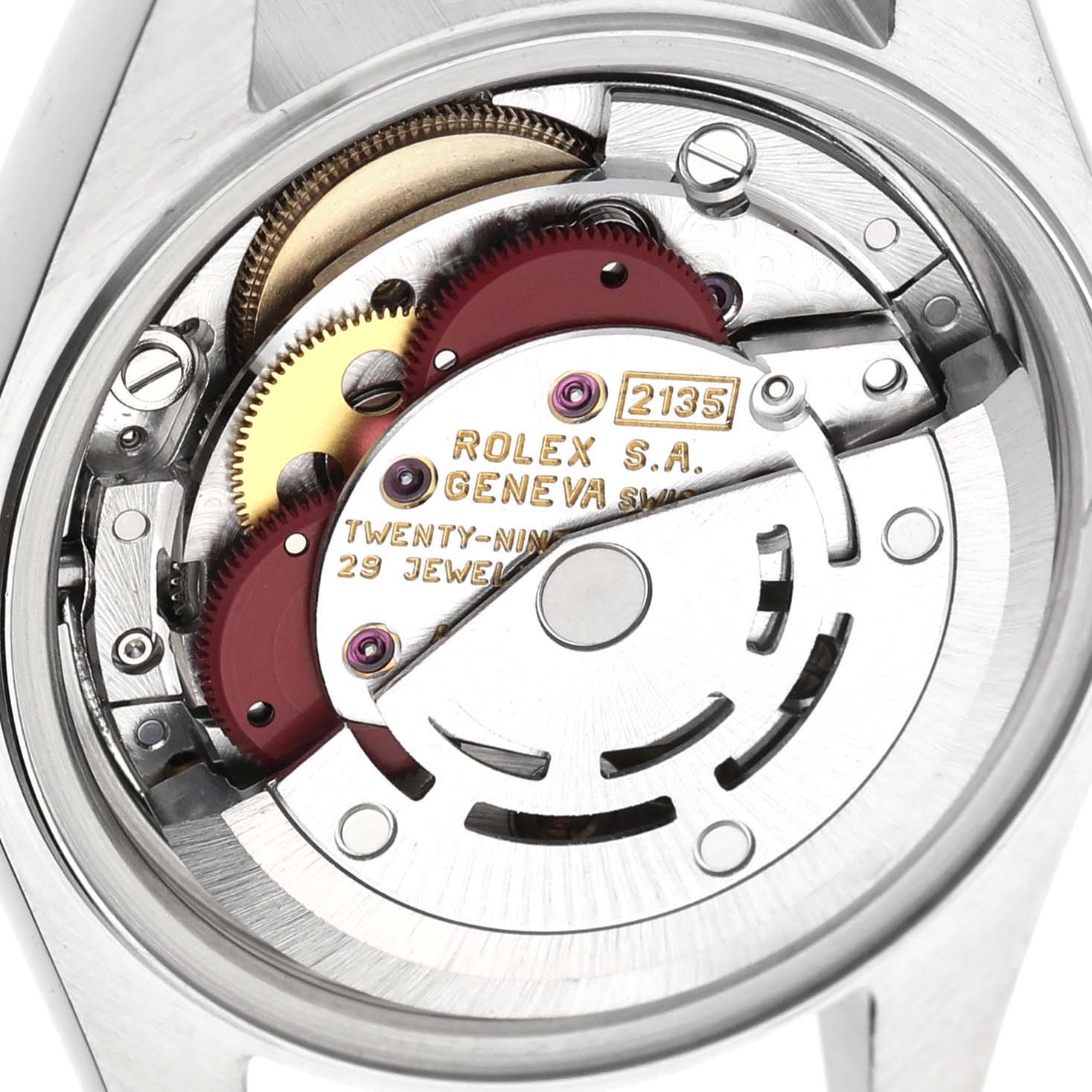 The image shows a detailed view of the Rolex Datejust 69173 Women's Steel and Gold (two tone) Champagne Dial movement, highlighting gears and inscriptions from the back.