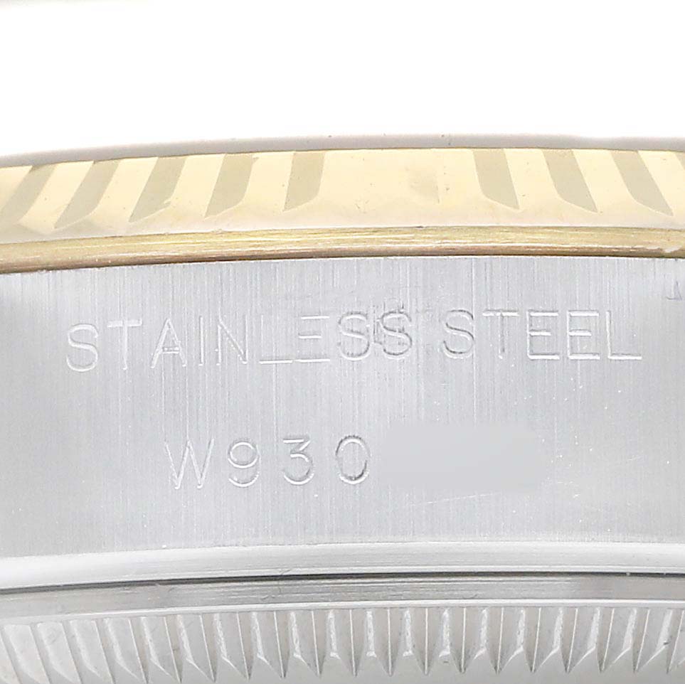 The image shows a close-up of a Rolex Datejust 69173 Women's Steel and Gold (two tone) Champagne Dial watch case, highlighting the stainless steel material and part of the fluted bezel.