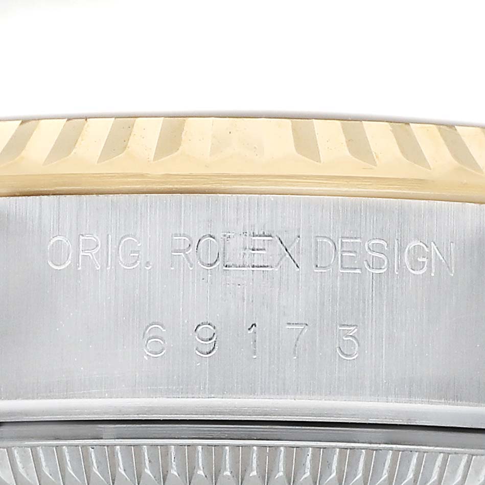 The image shows a close-up of the Rolex Datejust 69173 Women's Steel and Gold (two tone) Champagne Dial's engraved case with a focus on the model number.