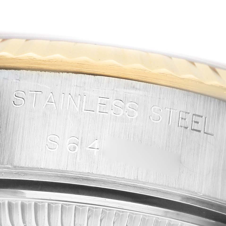 The image shows a close-up of the side of a Rolex Datejust 69173 Men's Steel and Gold (two tone) White Dial watch, highlighting the stainless steel material and fluted bezel.