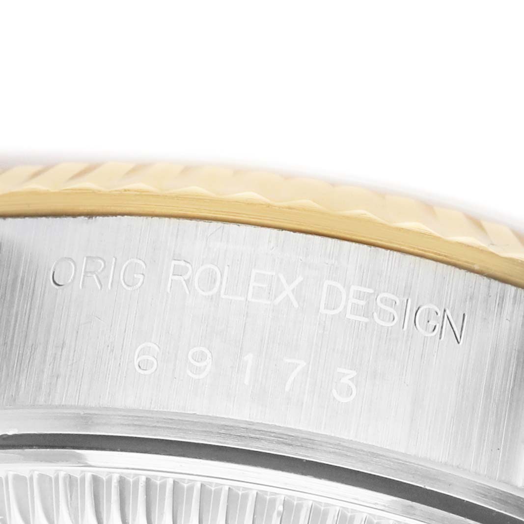 The image shows a close-up of the Rolex Datejust 69173 Men's Steel and Gold (two tone) White Dial's engraved case side, displaying the "Orig Rolex Design" text and model number.