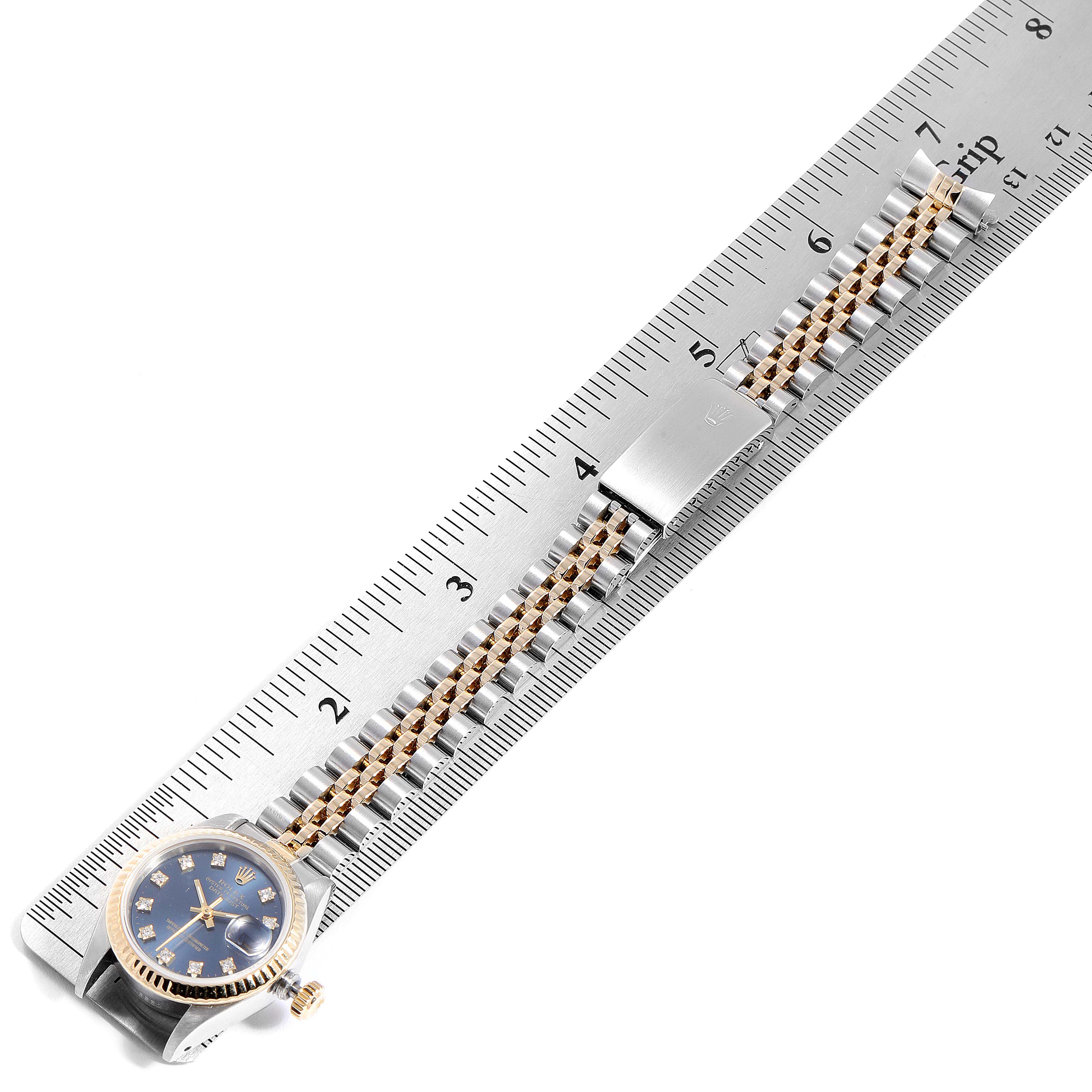 This image shows a Rolex Datejust 69173 Women's Steel and Gold (two tone) Blue Dial 69173 Women's Steel and Gold (two tone) Blue Dial watch placed alongside a ruler, highlighting its face, bezel, and bracelet.