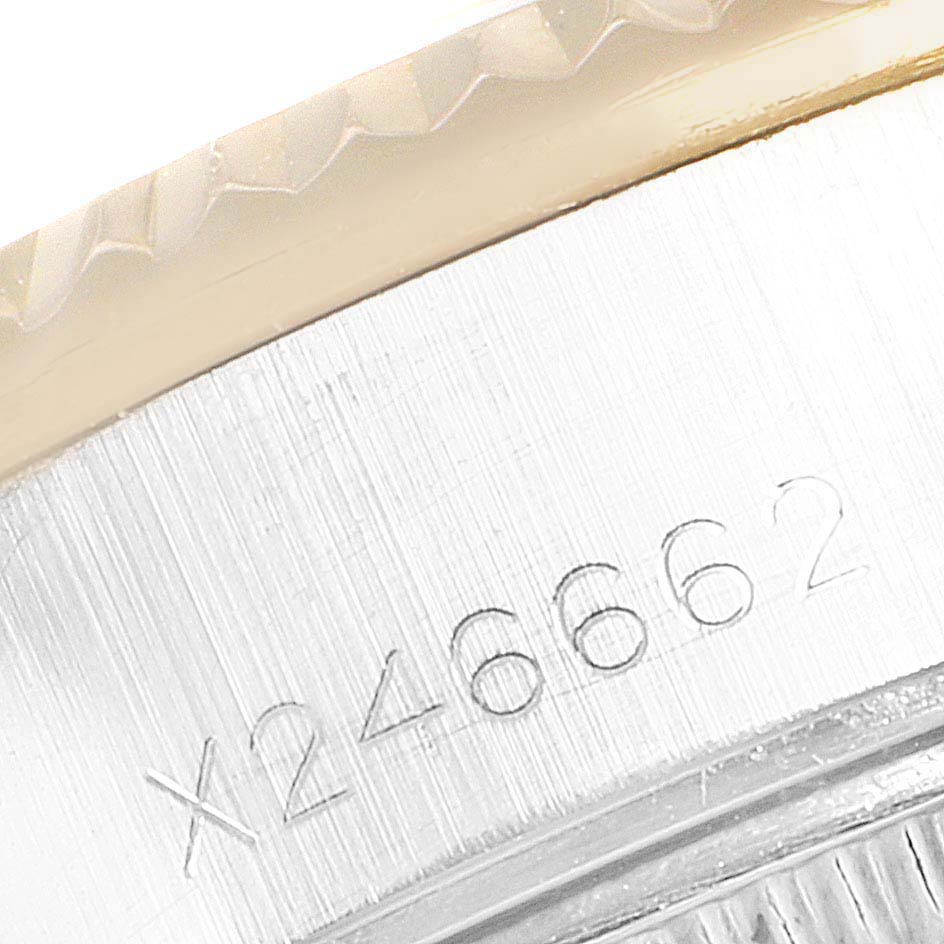 This is a close-up of the serial number engraving on the case side of a Rolex Datejust 69173 Women's Steel and Gold (two tone) Blue Dial 69173 Women's Steel and Gold (two tone) Blue Dial watch.