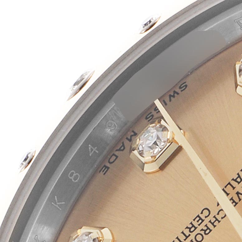 The image shows a close-up of the Rolex Mid-Size 278343 Women's Steel and Gold (two tone) Champagne Dial 278343 Women's Steel and Gold (two tone) Champagne Dial watch dial edge, highlighting the bezel, diamond markers, and partial text.