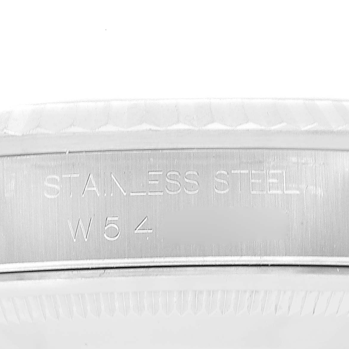 This image shows the side of the caseback of a Rolex Datejust 16234 Men's Stainless Steel Black Dial 16234 Men's Stainless Steel Black Dial watch, with "STAINLESS STEEL" and a partial serial number visible.