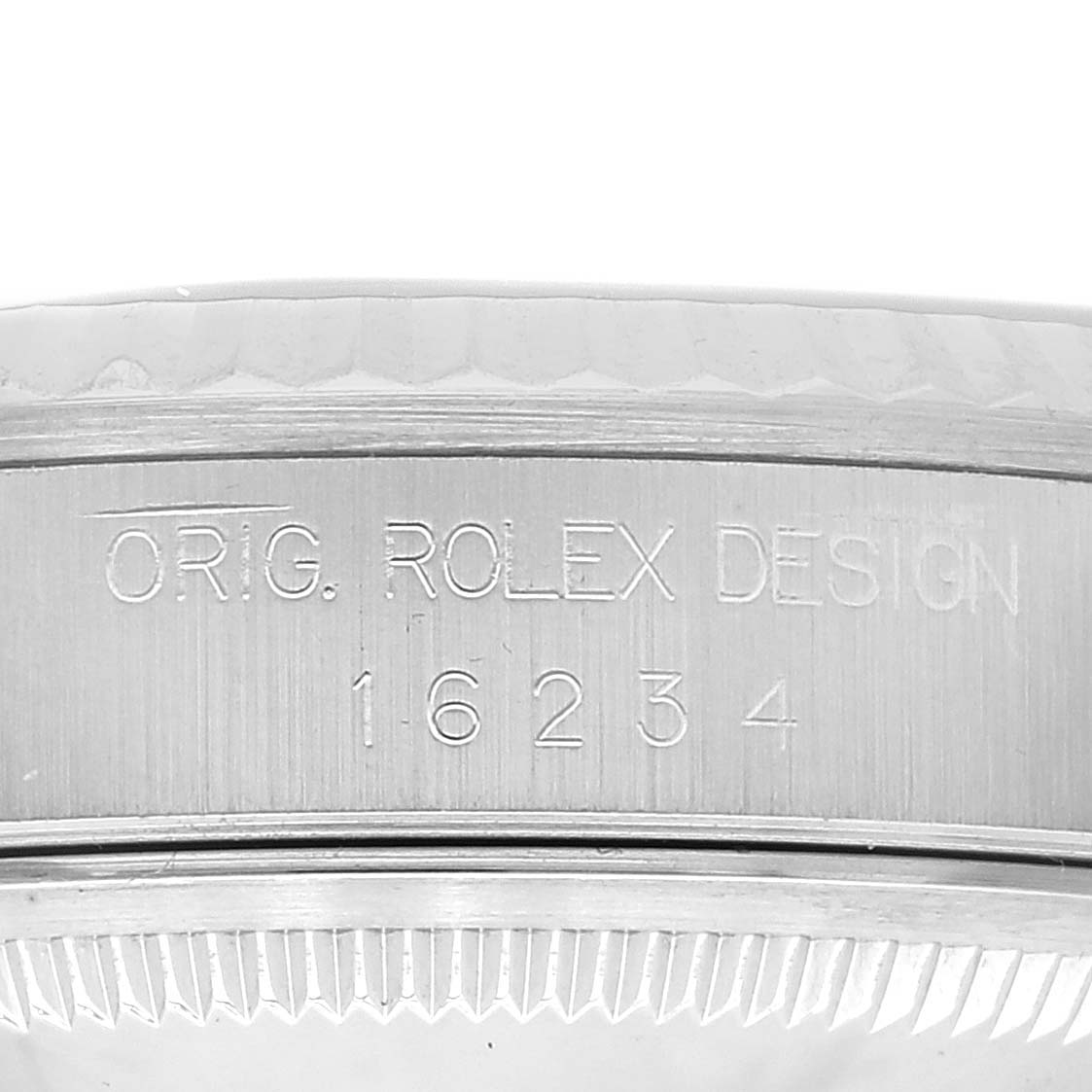 The image shows a close-up of the engraved side of the Rolex Datejust 16234 Men's Stainless Steel Black Dial 16234 Men's Stainless Steel Black Dial model, displaying "ORIG. ROLEX DESIGN" and the model number "16234".