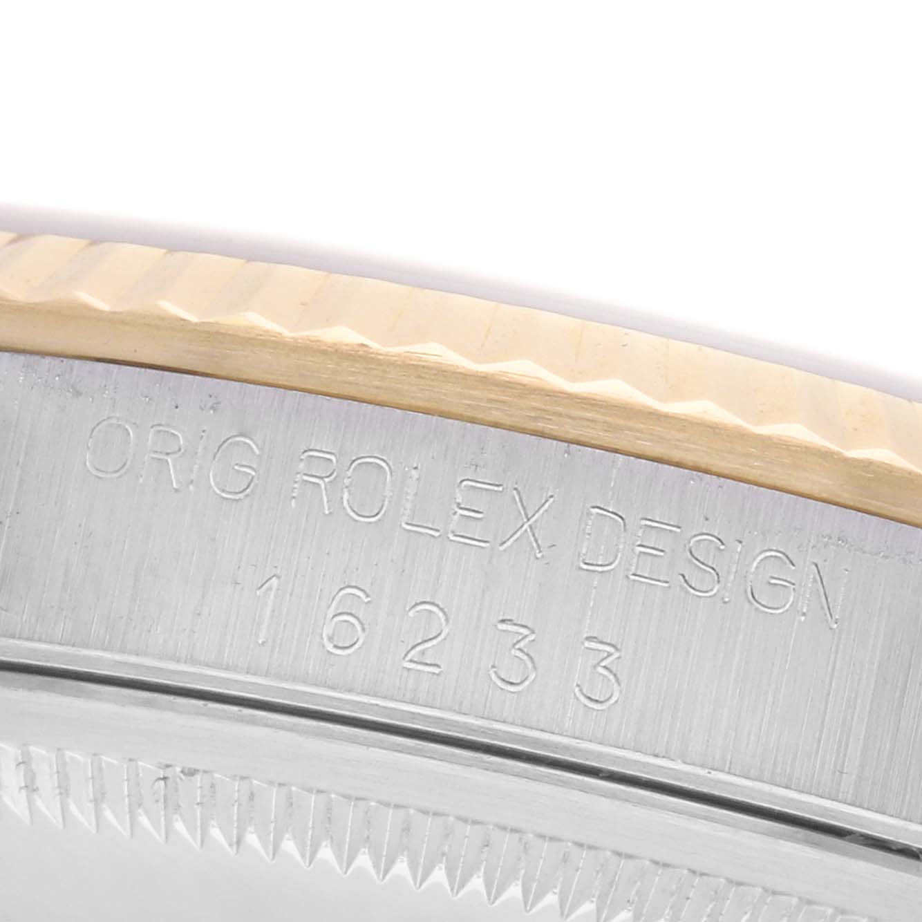 The image shows a close-up of the Rolex Datejust 16233 Men's Steel and Gold (two tone) Champagne Dial 16233 Men's Steel and Gold (two tone) Champagne Dial's case side, highlighting the engraved model number and design marking.