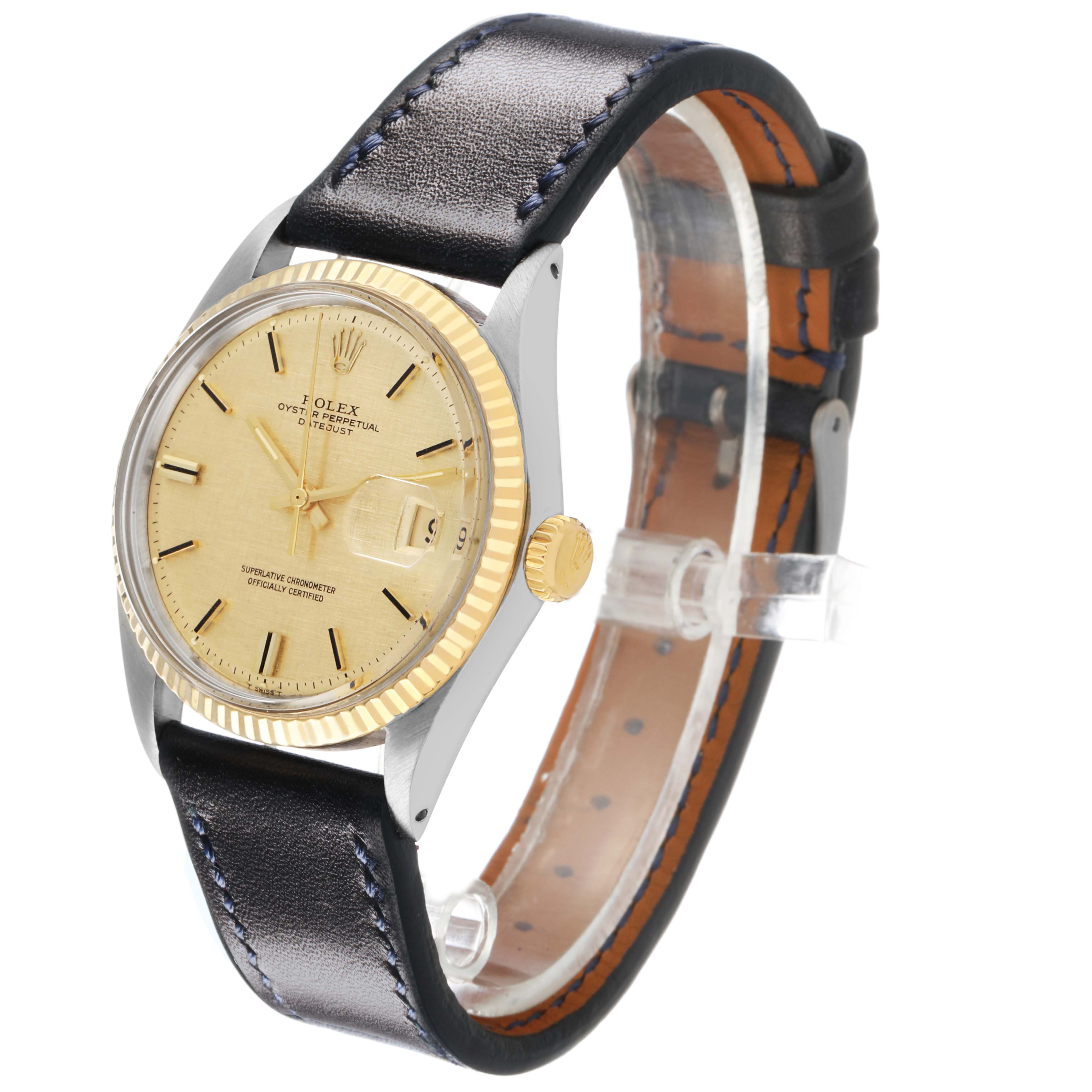 The Rolex Datejust 1601 Men's Steel and Gold (two tone) Champagne Dial watch is shown from an angle highlighting its face, fluted bezel, and black leather strap.