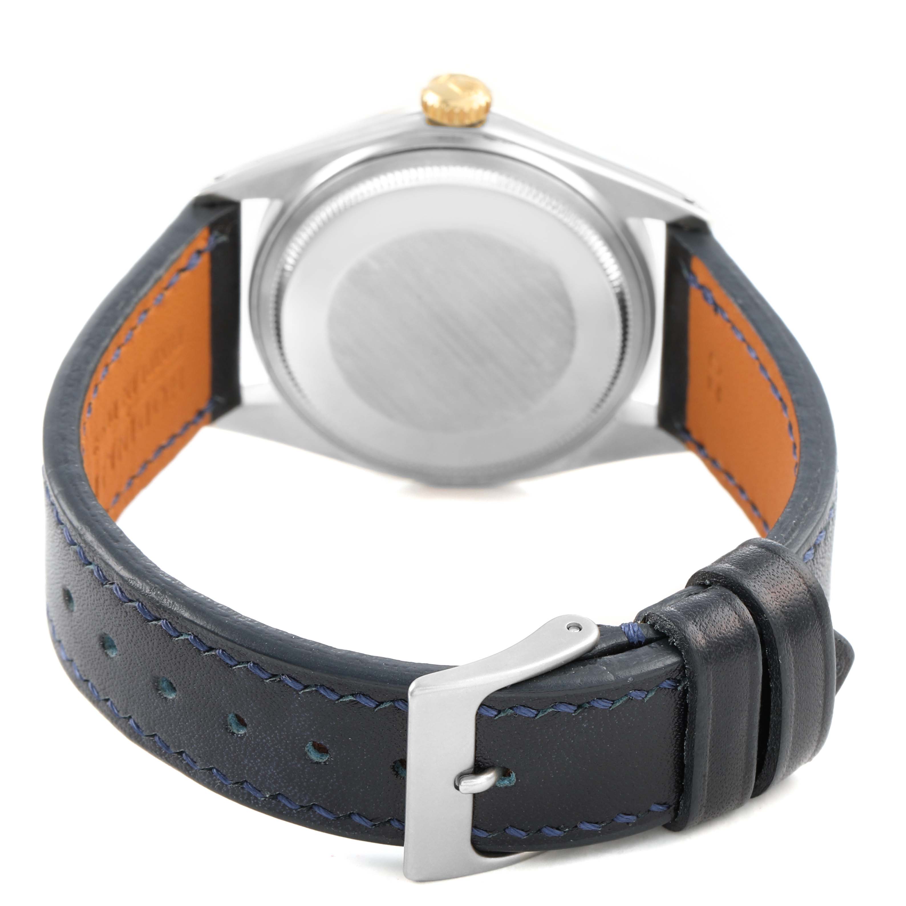 The image shows the back of the Rolex Datejust 1601 Men's Steel and Gold (two tone) Champagne Dial watch, focusing on the case back, crown, and leather strap with a buckle.
