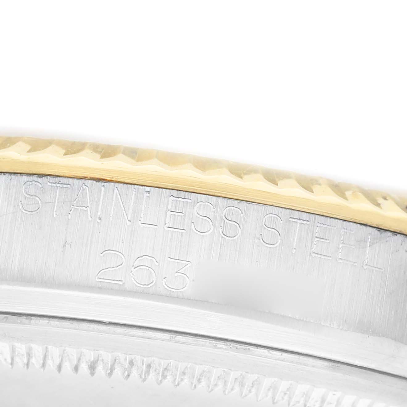 The image shows a close-up of the bezel and case side of a Rolex Datejust 1601 Men's Steel and Gold (two tone) Champagne Dial, highlighting the "STAINLESS STEEL" inscription.