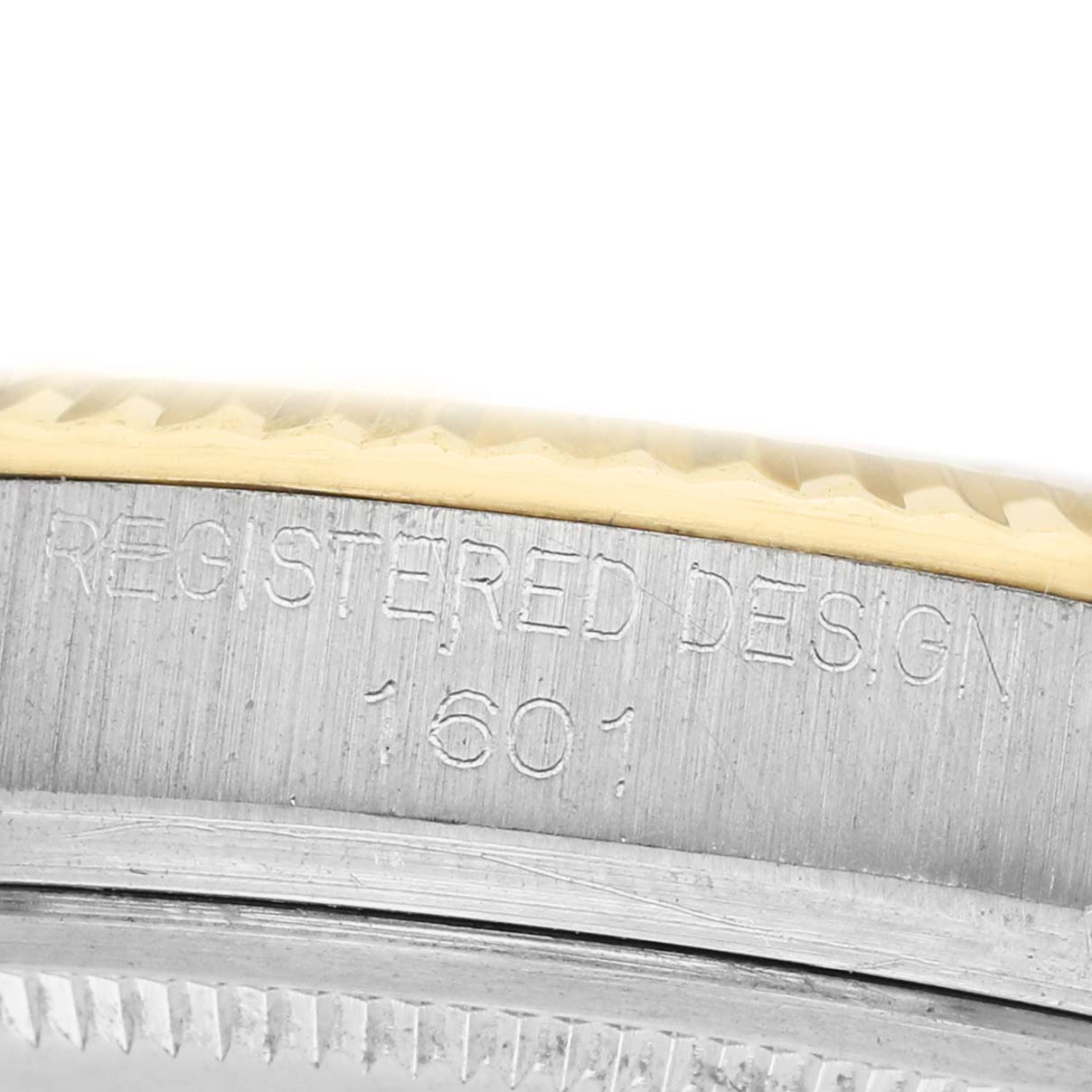 The image shows a close-up of the serial engraving on the side of a Rolex Datejust 1601 Men's Steel and Gold (two tone) Champagne Dial watch case.