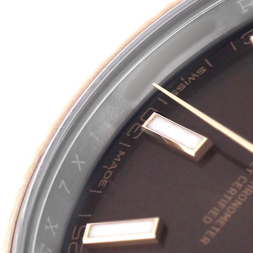 The image shows a close-up of the black dial and markers of the Rolex Datejust 41 126331 Men's Steel and Gold (two tone) Brown Dial, viewed at an angle highlighting the details.