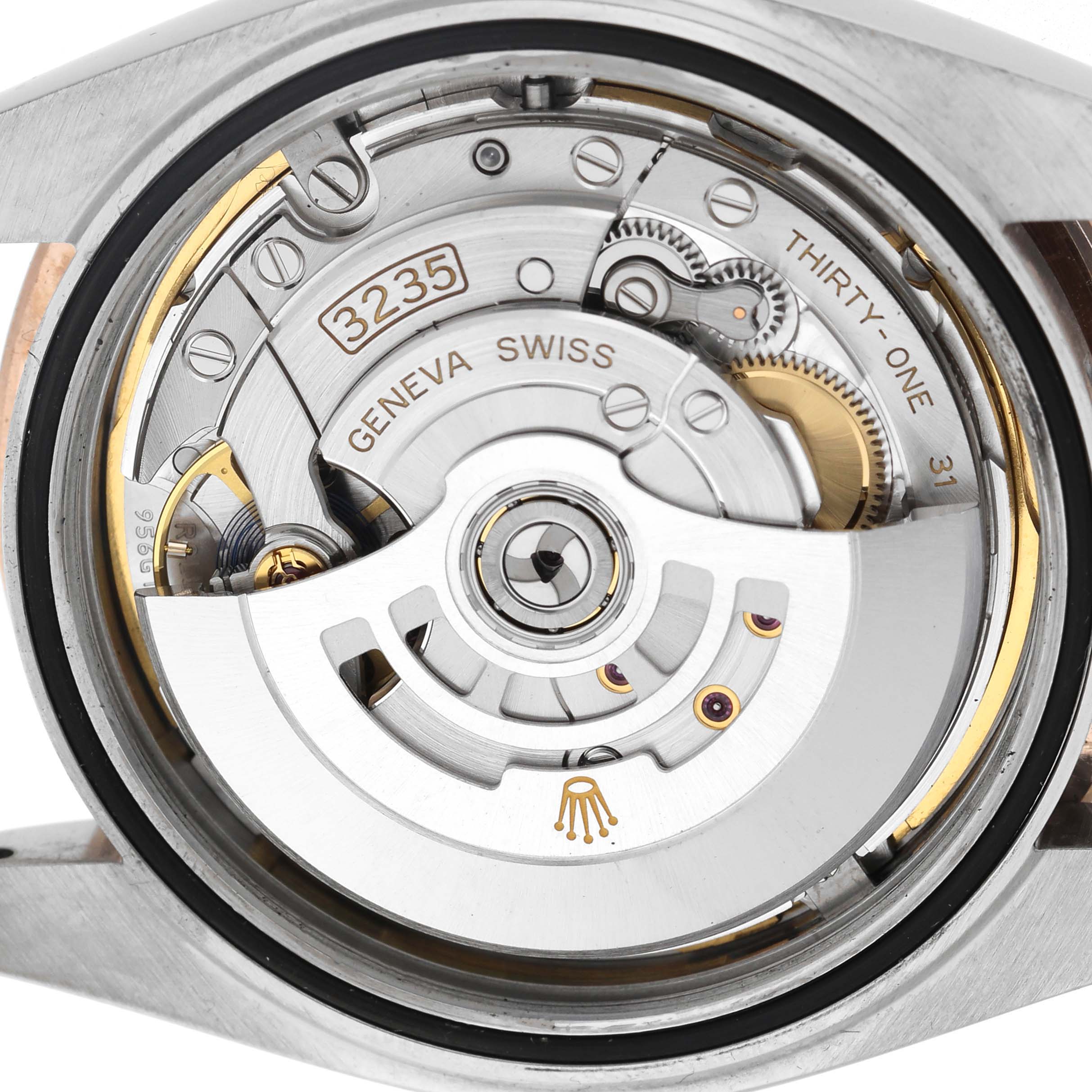 The image shows the Rolex Datejust 41 126331 Men's Steel and Gold (two tone) Brown Dial's movement from a back view, highlighting the rotor and internal mechanisms.
