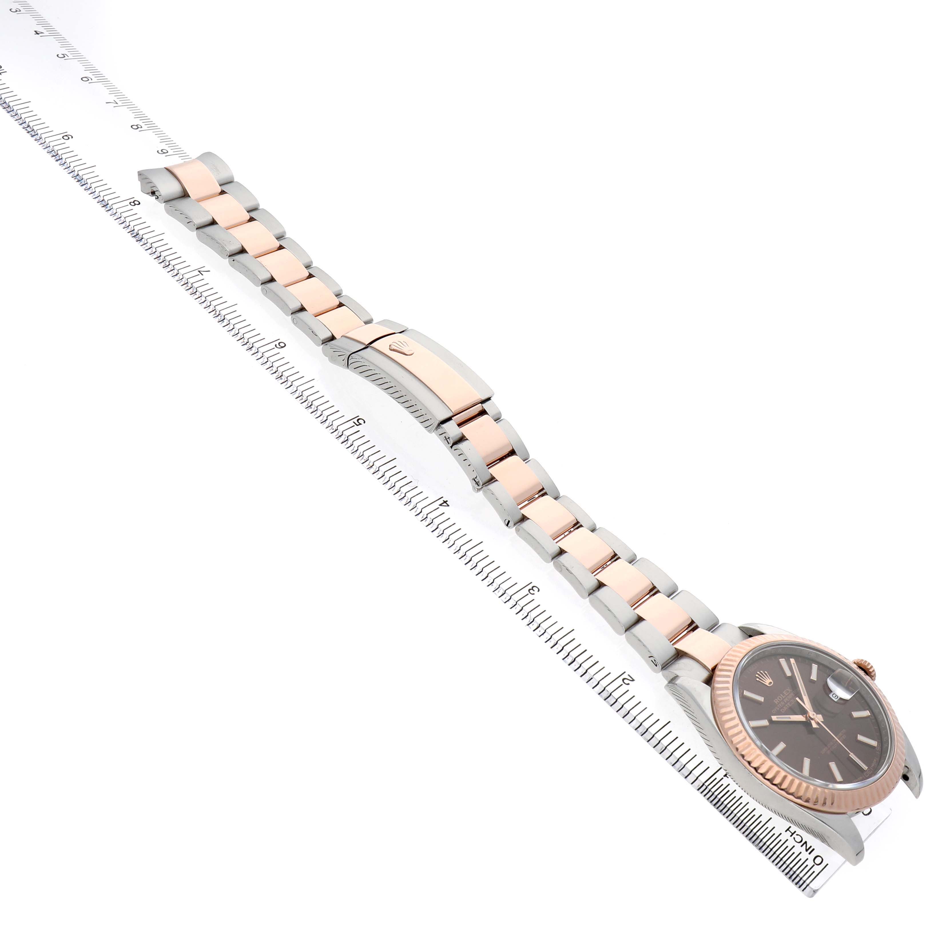 The image shows a Rolex Datejust 41 126331 Men's Steel and Gold (two tone) Brown Dial watch with a rose gold and silver bracelet, displayed diagonally alongside a ruler.