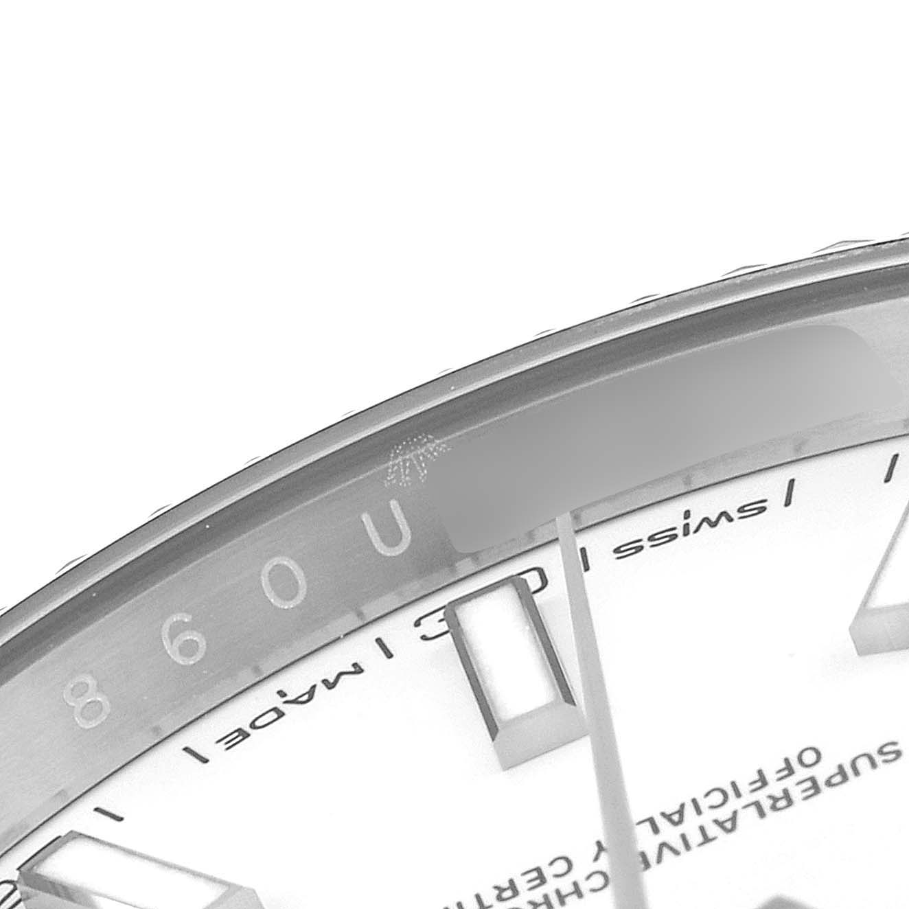 The image shows a close-up of the dial and edge of the bezel of a Rolex Datejust 126334 Men's Stainless Steel White Dial 126334 Men's Stainless Steel White Dial watch, highlighting part of the text and markers.