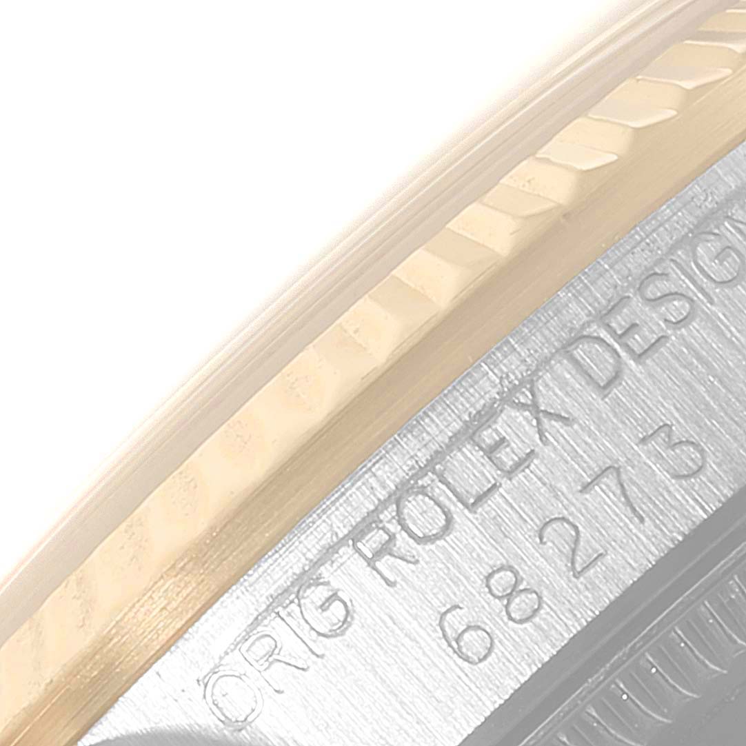 This close-up image shows the bezel and part of the engraved case of the Rolex Mid-Size 68273 Women
s Steel and Gold (two tone) Silver Dial 68273 Women
s Steel and Gold (two tone) Silver Dial model watch.