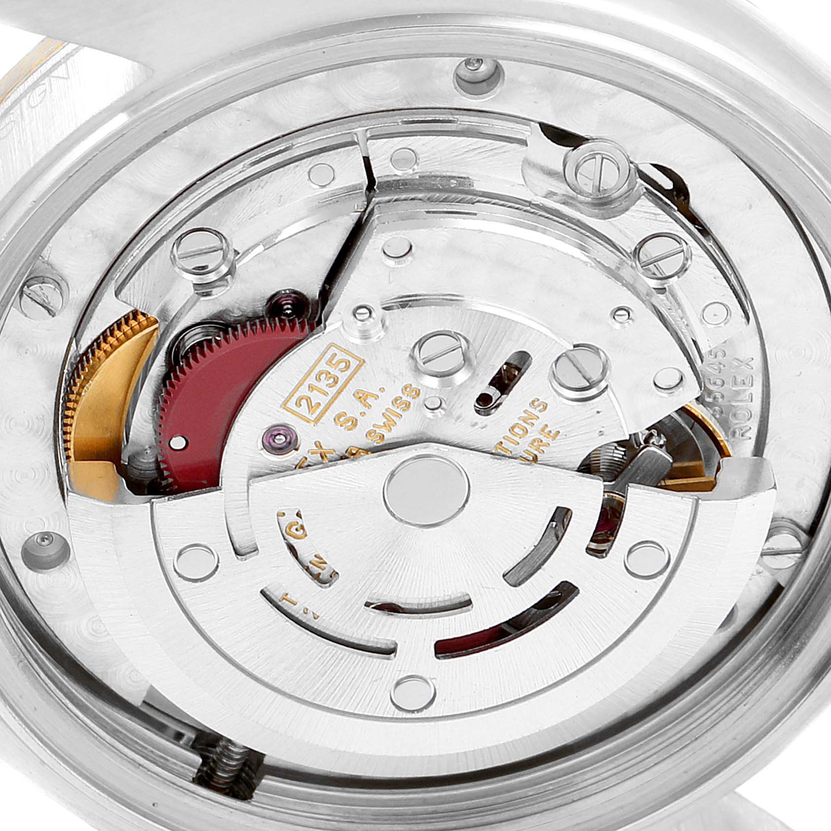 The image shows the internal mechanism of a Mid-Size Rolex watch from a close-up angle, focusing on the movement components.