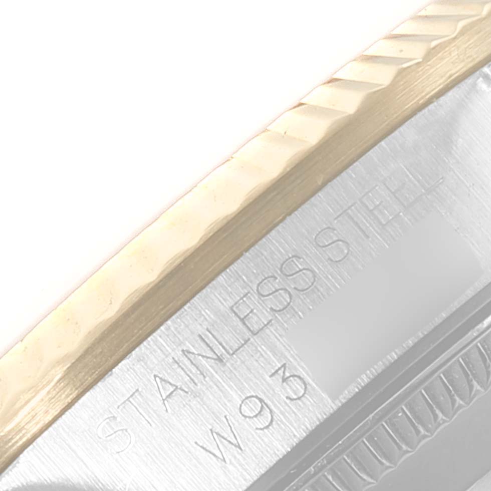 This image shows a close-up of the edge and engraving on a mid-size Rolex watch, specifically "STAINLESS STEEL" on the casing.