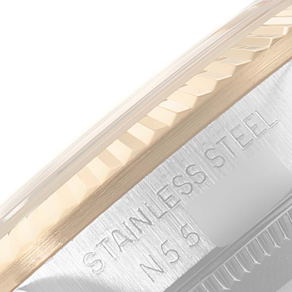 The image shows a close-up of the bezel and case side of a Rolex Mid-Size 68273 Women
s Steel and Gold (two tone) Champagne Dial 68273 Women
s Steel and Gold (two tone) Champagne Dial model, highlighting the stainless steel text.