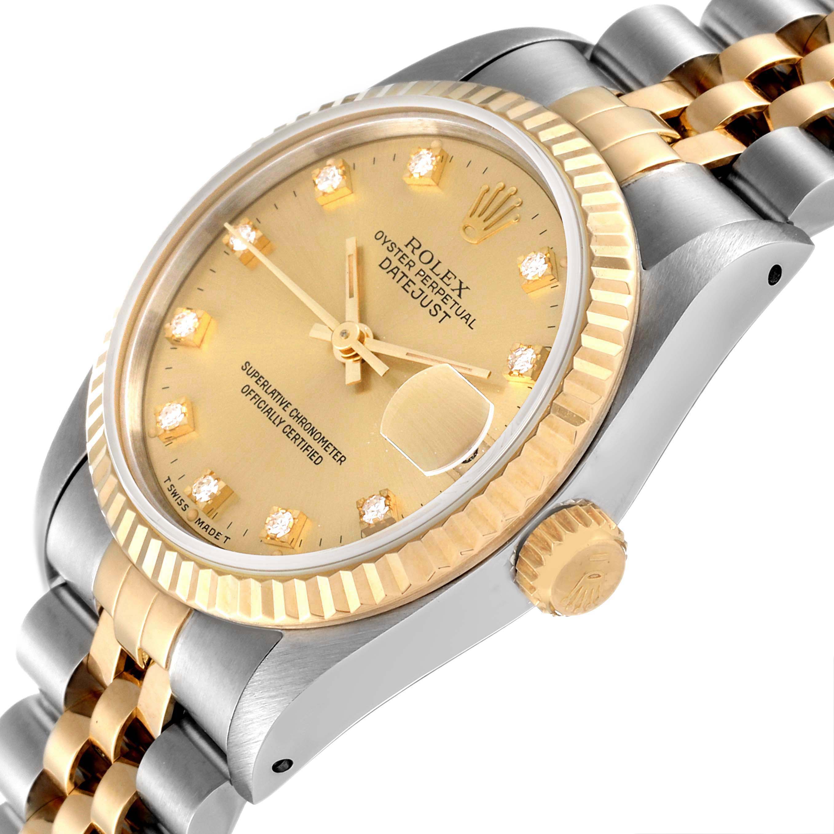 This Rolex Mid-Size 68273 Women
s Steel and Gold (two tone) Champagne Dial 68273 Women
s Steel and Gold (two tone) Champagne Dial model
s angled view showcases its gold dial, fluted bezel, crown, and two-tone bracelet.