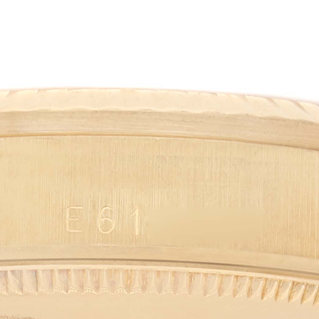 The image shows a close-up of the side of the Rolex President 68278 Women's Yellow Gold Champagne Dial 68278 Women's Yellow Gold Champagne Dial model watch, highlighting its serial number and part of the case.