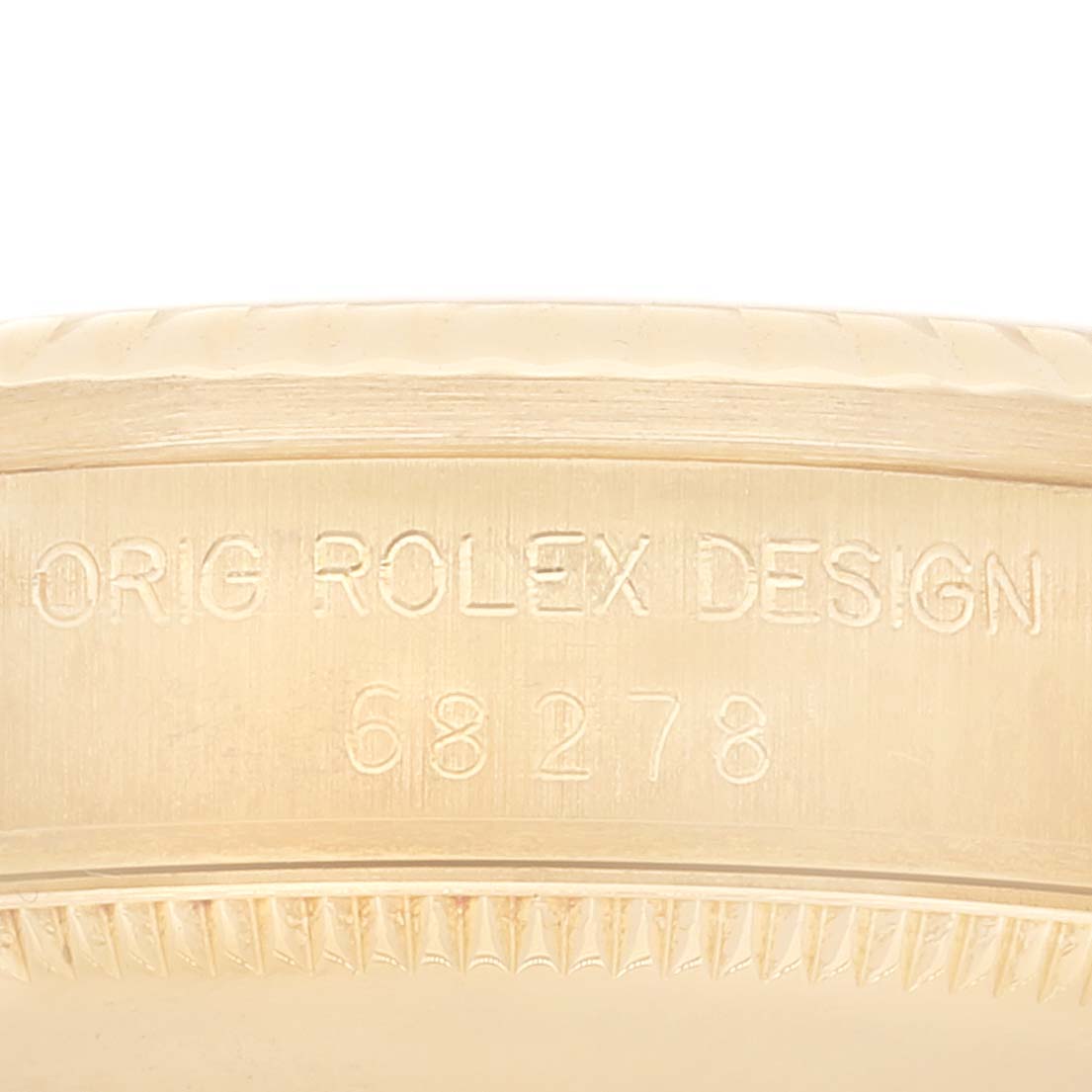 The image shows the serial number and design engraving on the inner bezel of a Rolex President 68278 Women's Yellow Gold Champagne Dial 68278 Women's Yellow Gold Champagne Dial model watch.