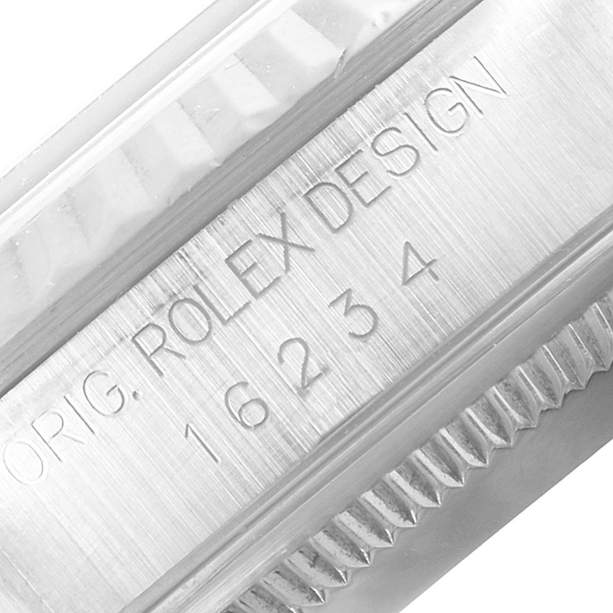 This close-up image shows the case side and part of the fluted bezel of a Rolex Datejust 16234 Men
s Stainless Steel Black Dial 16234 Men
s Stainless Steel Black Dial watch, with engraved branding.