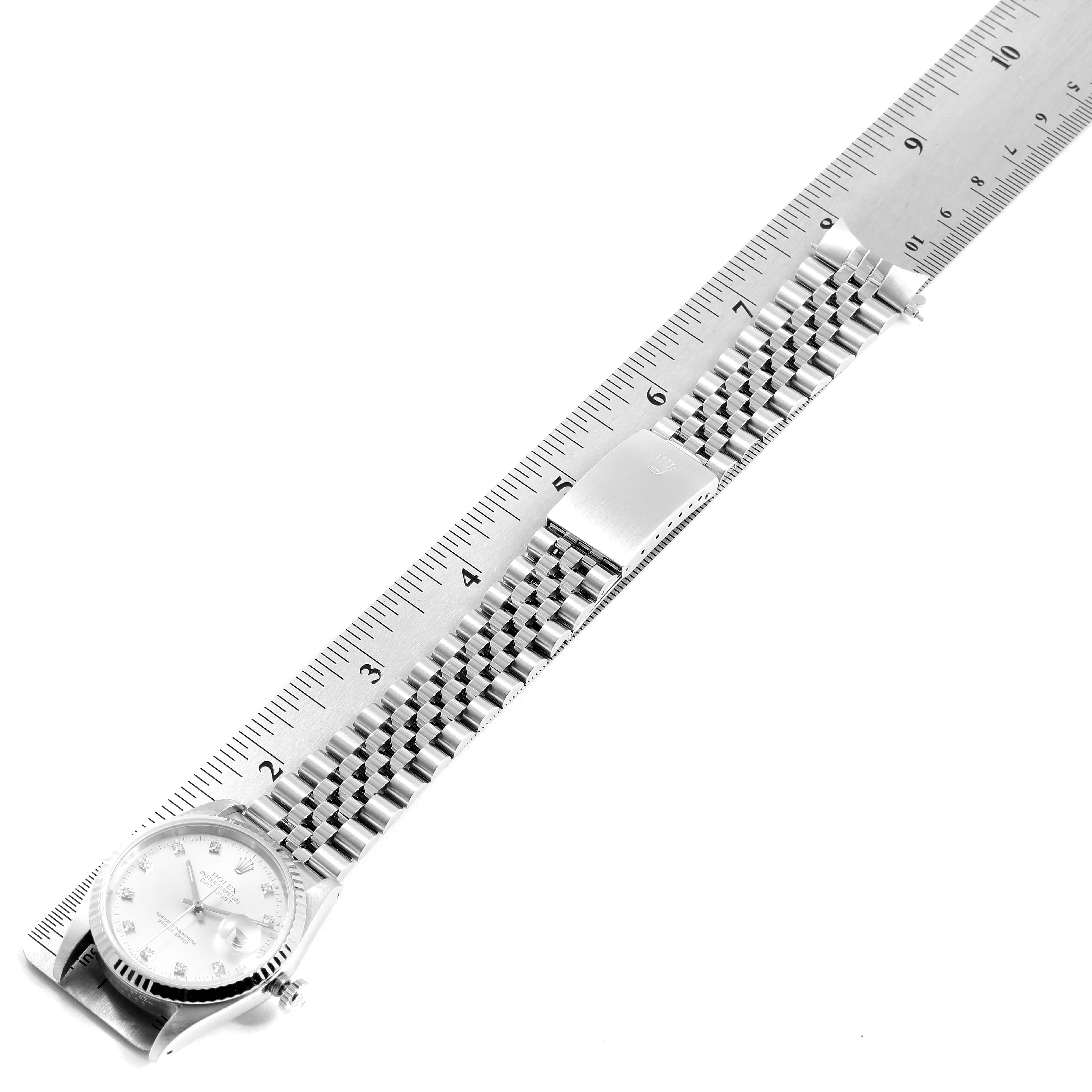 The image shows a Rolex Datejust 16234 Men's Stainless Steel Silver Dial 16234 Men's Stainless Steel Silver Dial watch with a jubilee bracelet laid alongside a ruler for measurement.